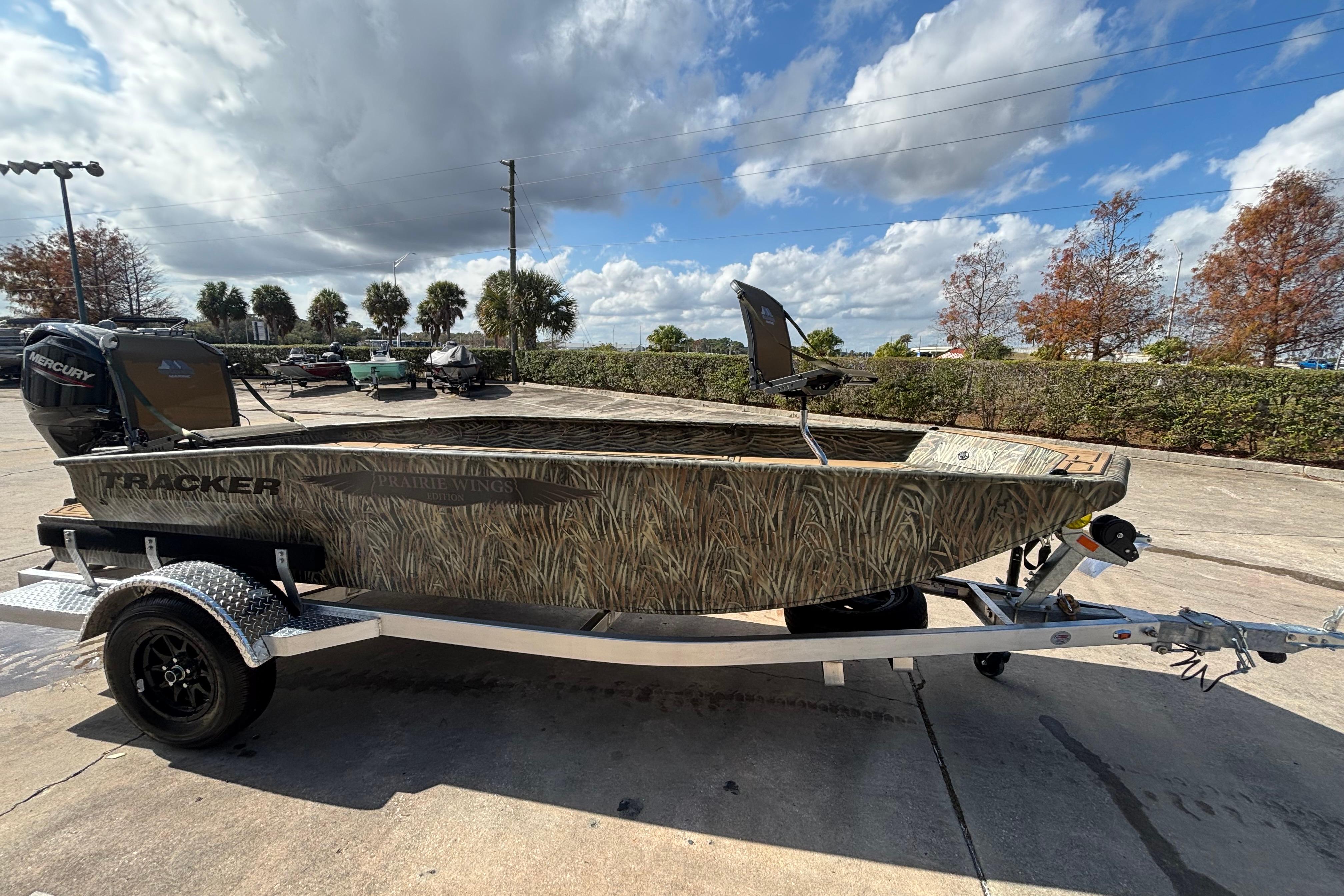 2026 Tracker Grizzly 1650 T Prairie Wings Edition boat on trailer, outdoors.