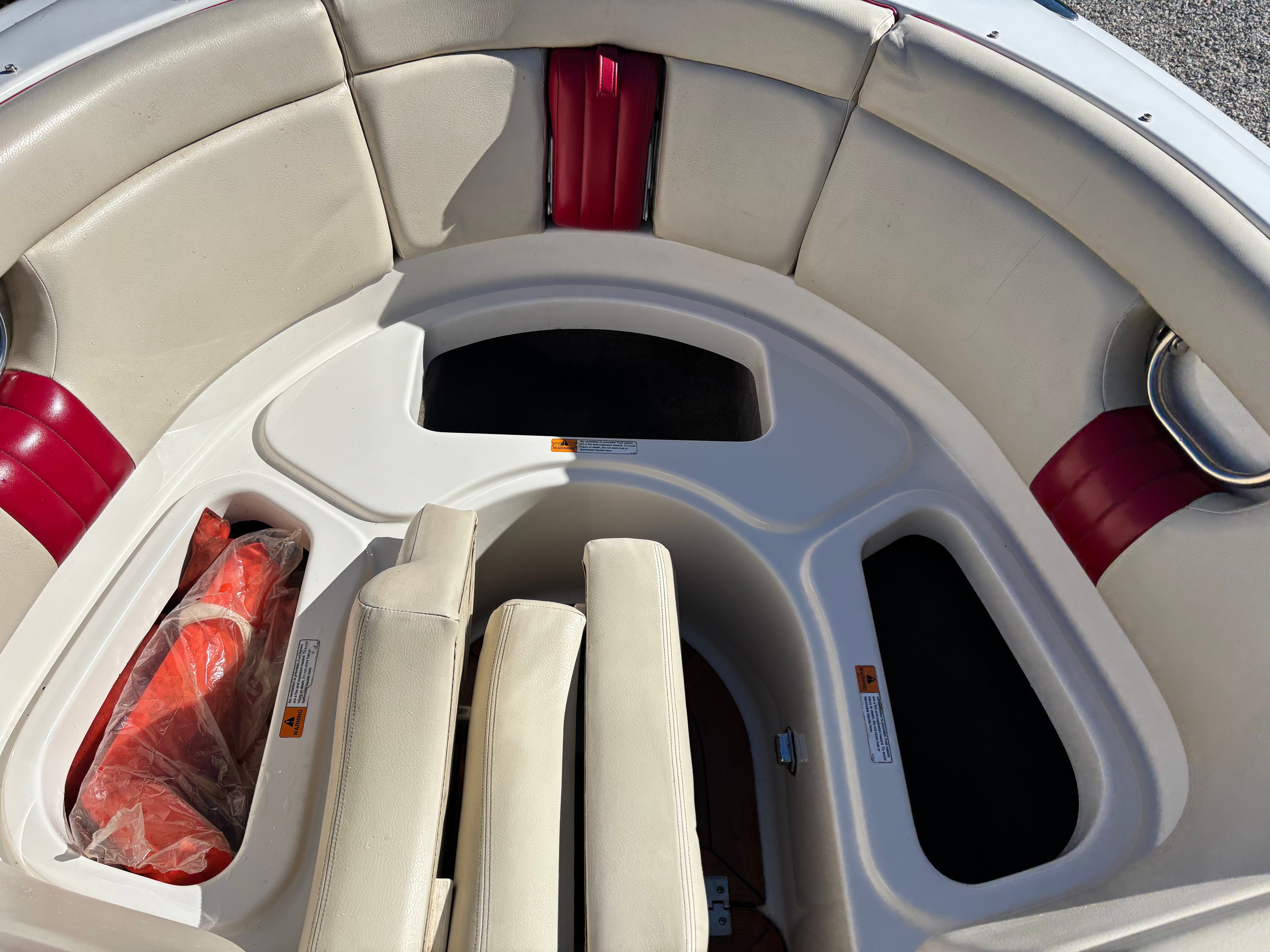 The image shows the bow area of a 2003 Chris-Craft Launch 22 boat with beige upholstery.