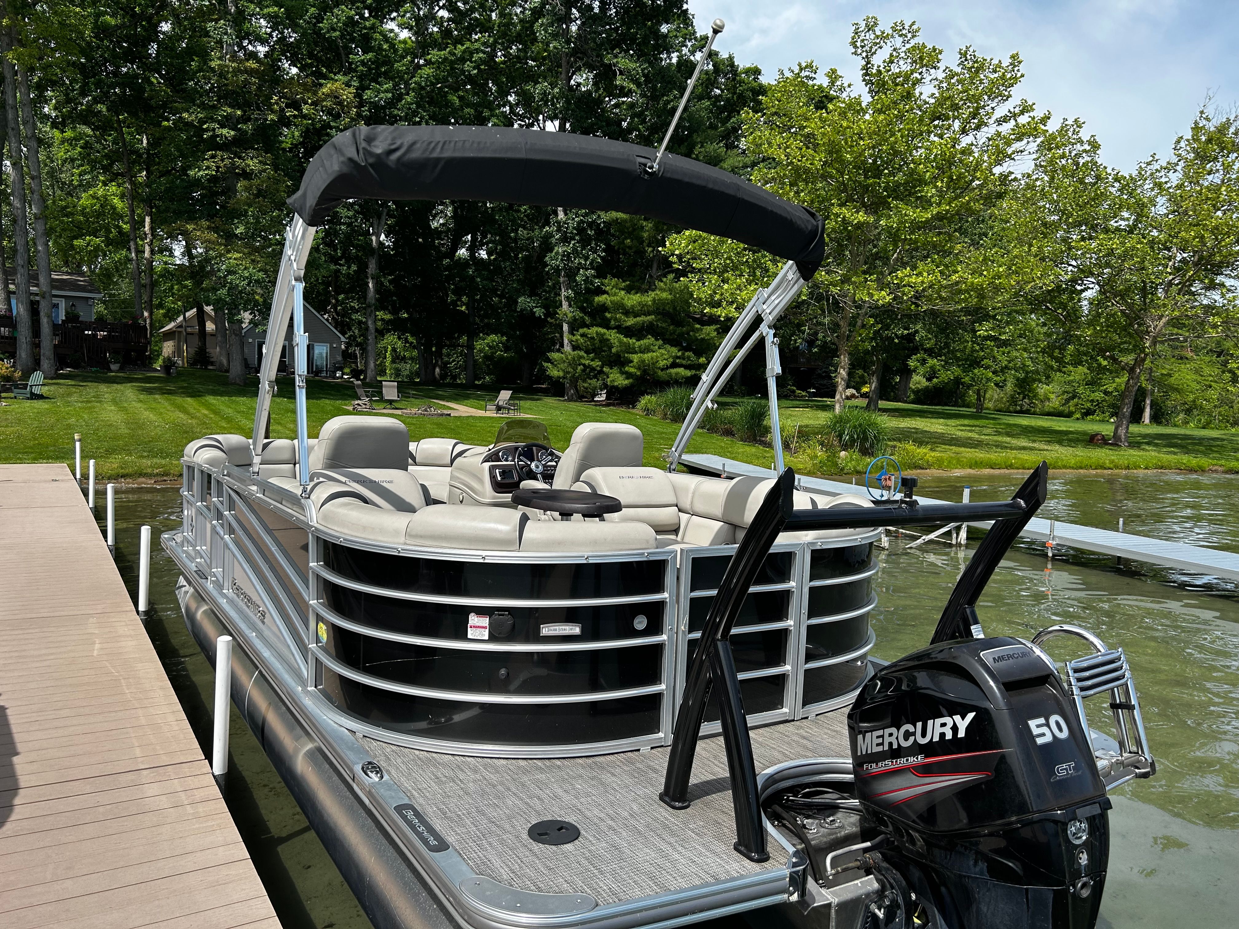 A 2018 Berkshire 21 RFX STS pontoon boat docked at a pier on a calm lake.