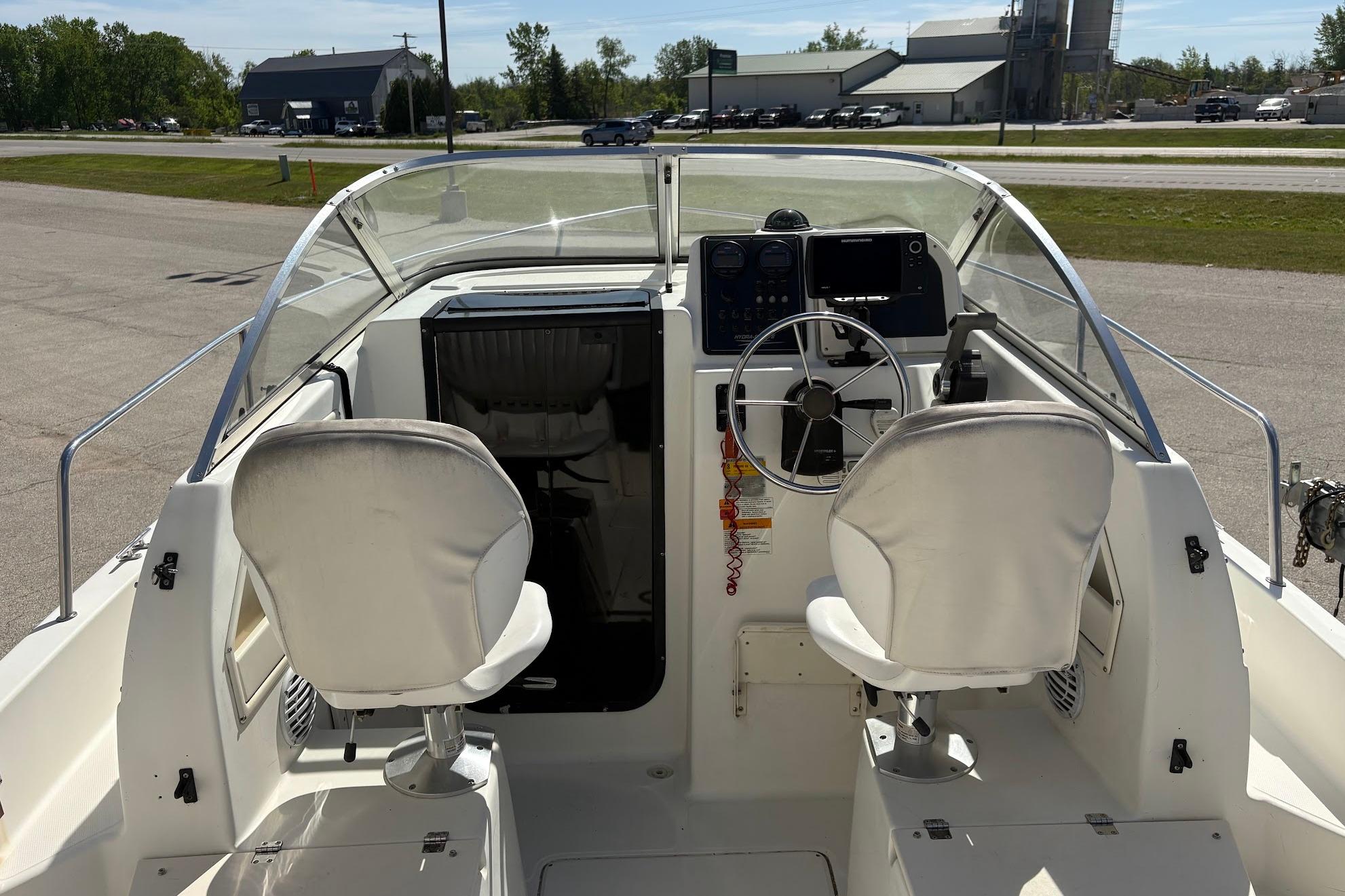 2002 Hydra-Sports 212 WA boat interior with steering wheel and seating.