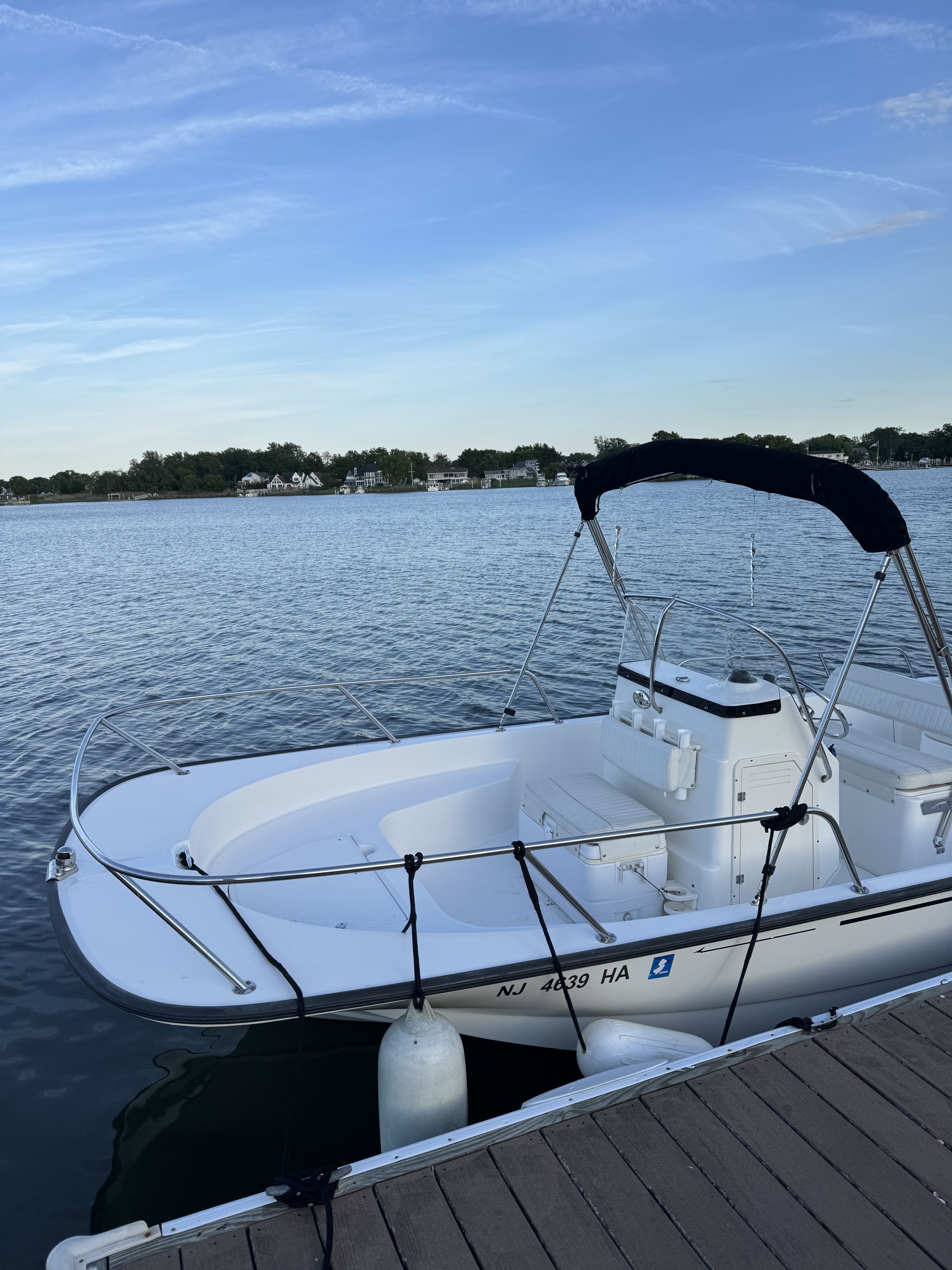 2007 Boston Whaler 190 Montauk boat docked by calm waters.