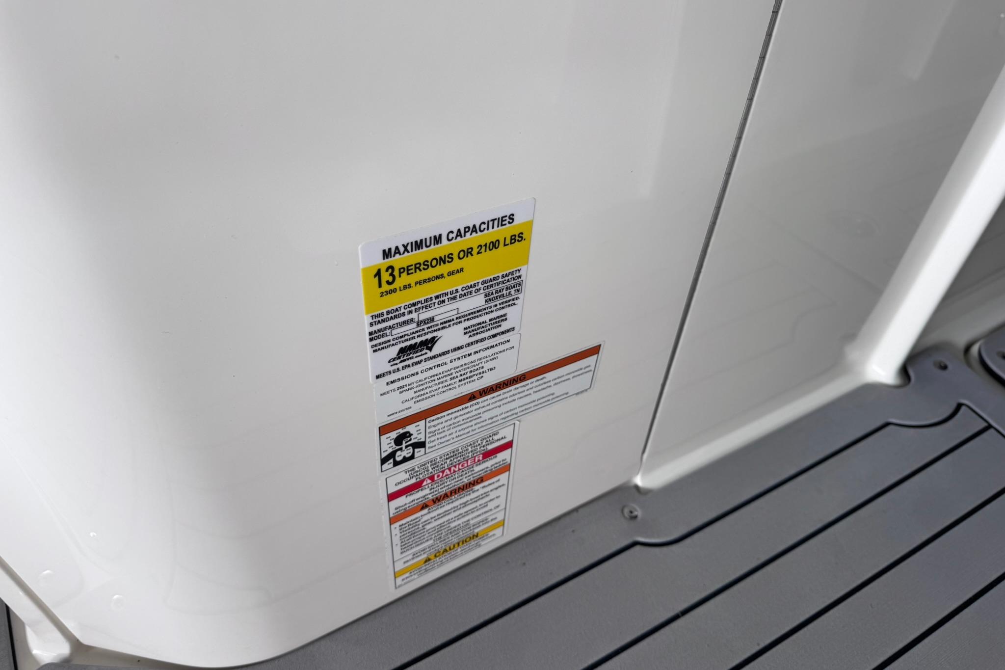 Capacity label on 2021 Sea Ray SPX 230 boat, maximum 13 persons or 2100 lbs.
