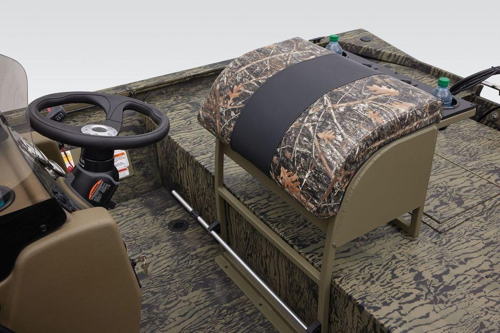 2026 Tracker GRIZZLY® 2072 CC Sportsman boat interior with camo seat and steering wheel.