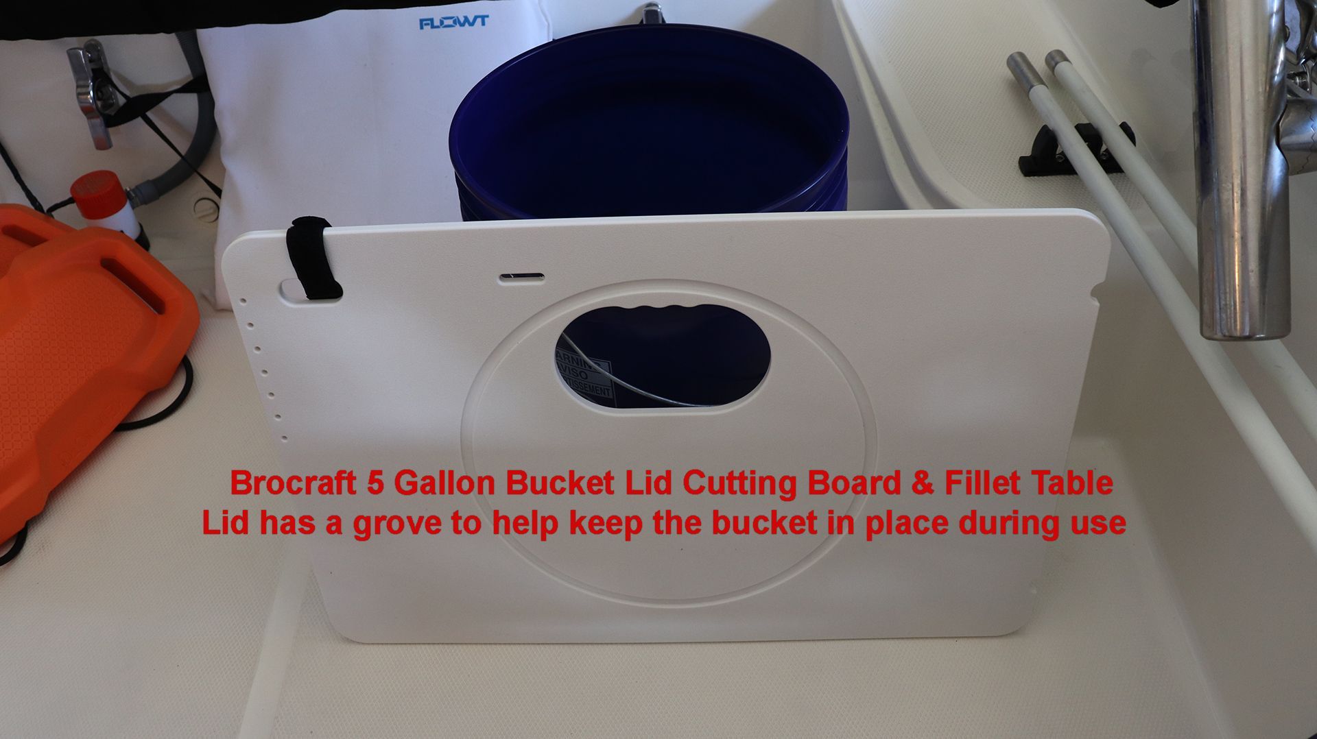 A cutting board with a bucket lid on a boat.