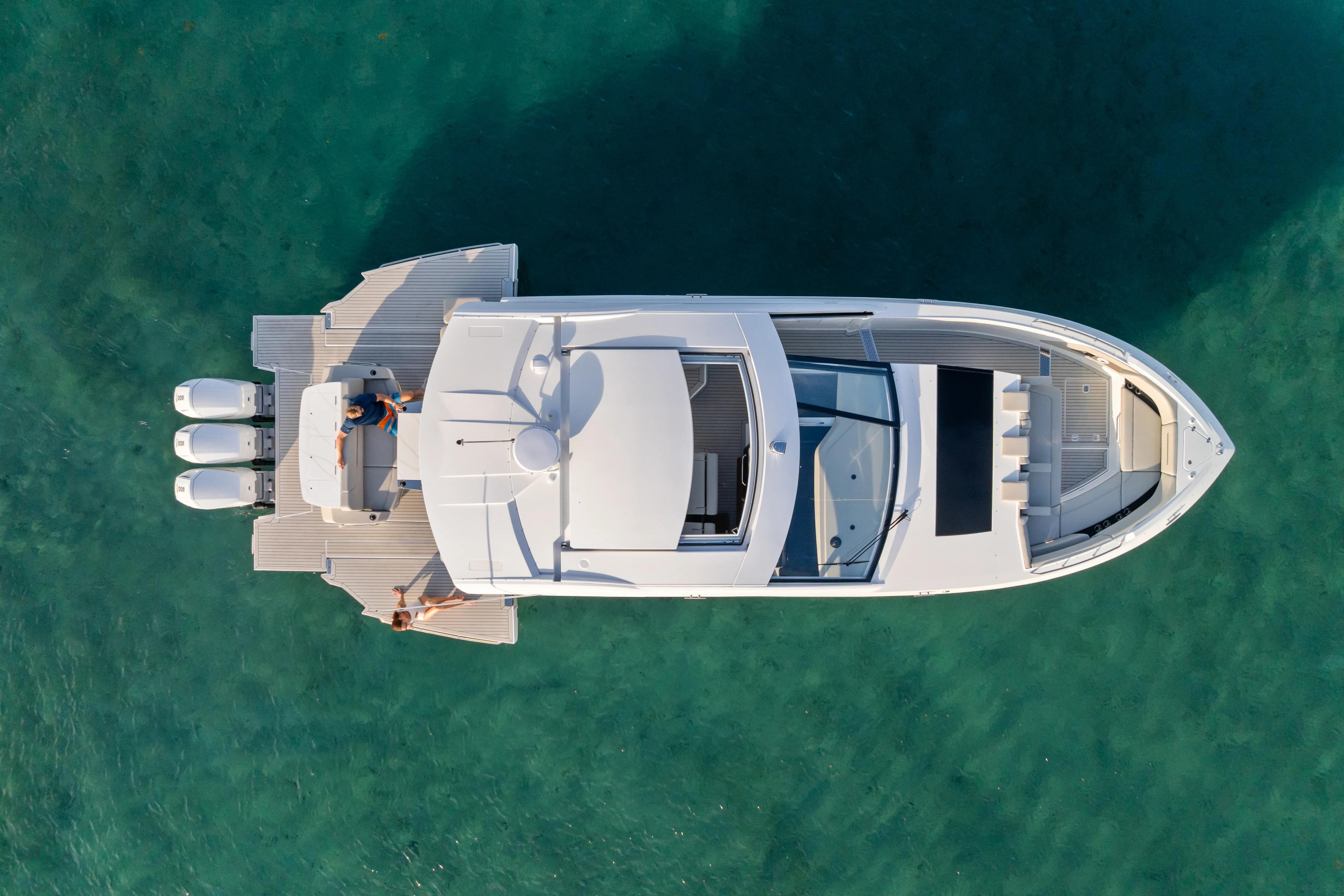 Aerial view of 2026 Cruisers Yachts 50 GLS on clear turquoise water.