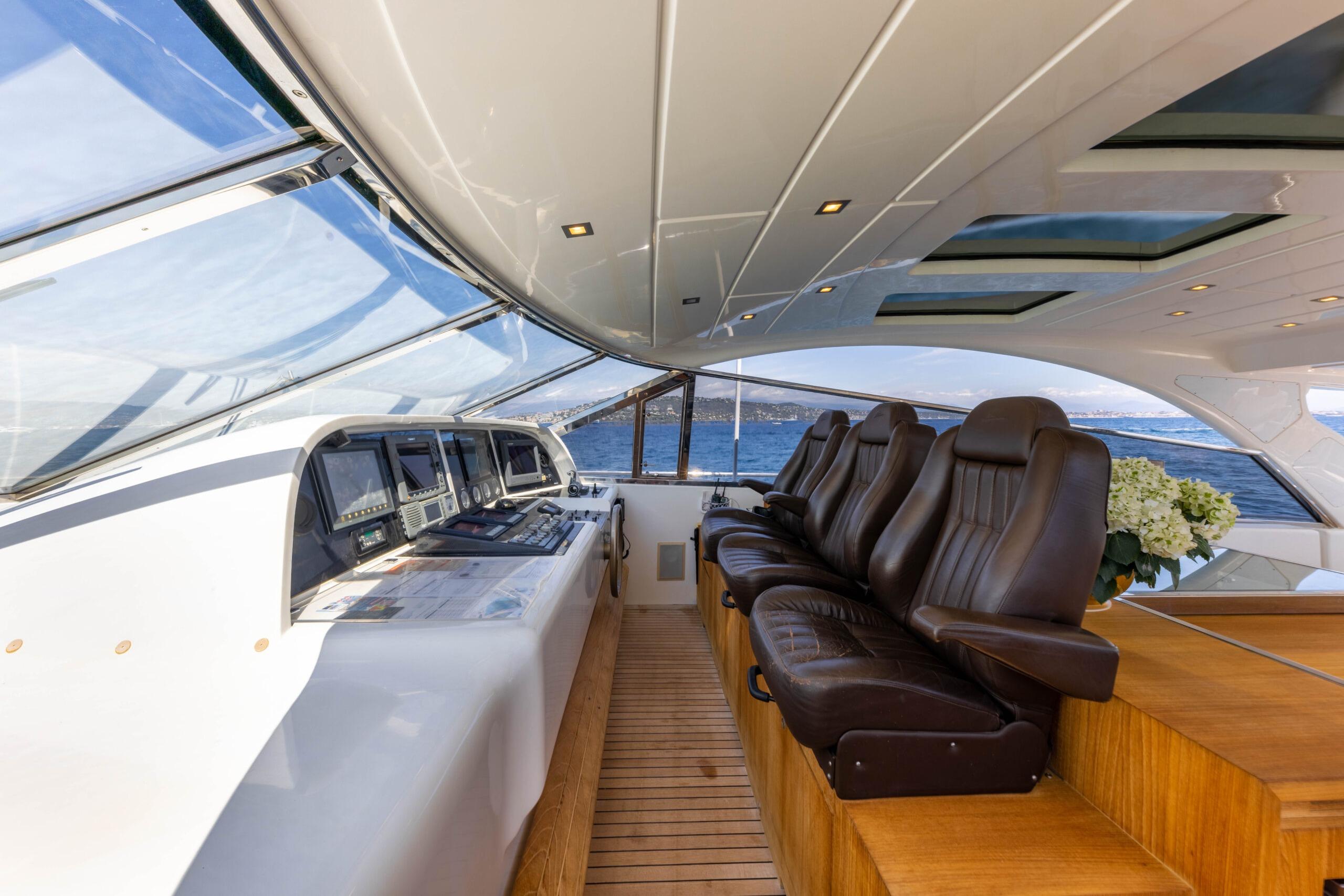 Luxurious interior of 2006 Mangusta 80 yacht with leather seating and panoramic windows.