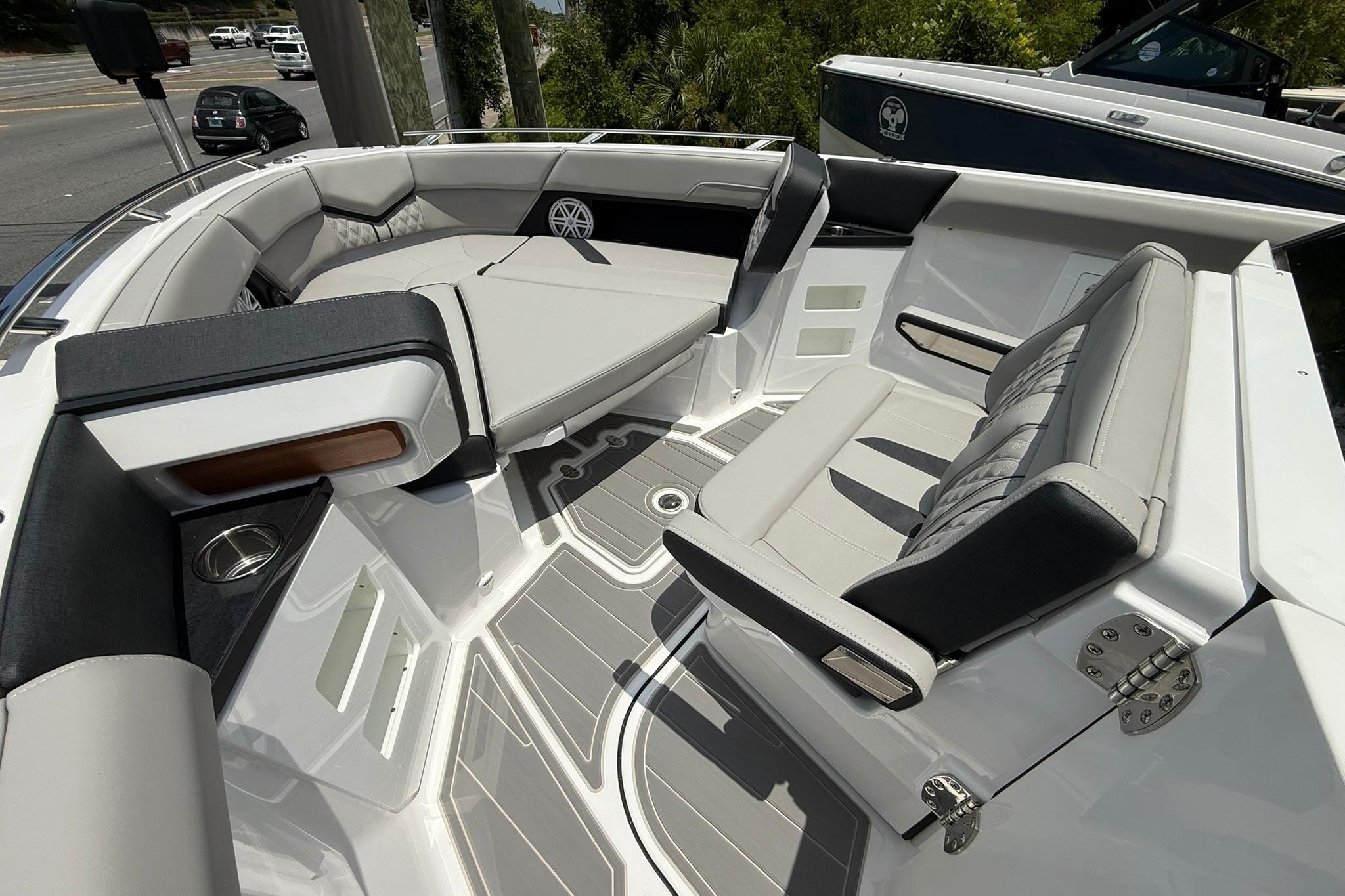 Luxurious seating area on the 2027 Monterey Elite 30 OB boat, featuring sleek design and comfort.