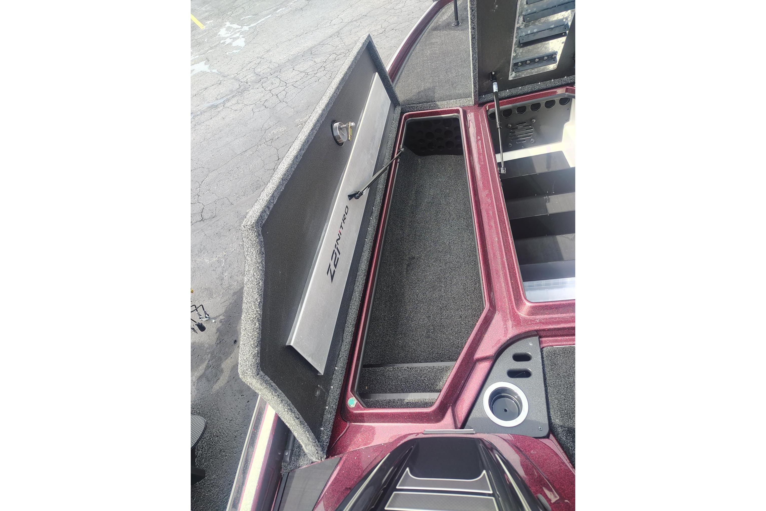 2024 Nitro Z21 XL boat storage compartment with open lid, showcasing interior space.