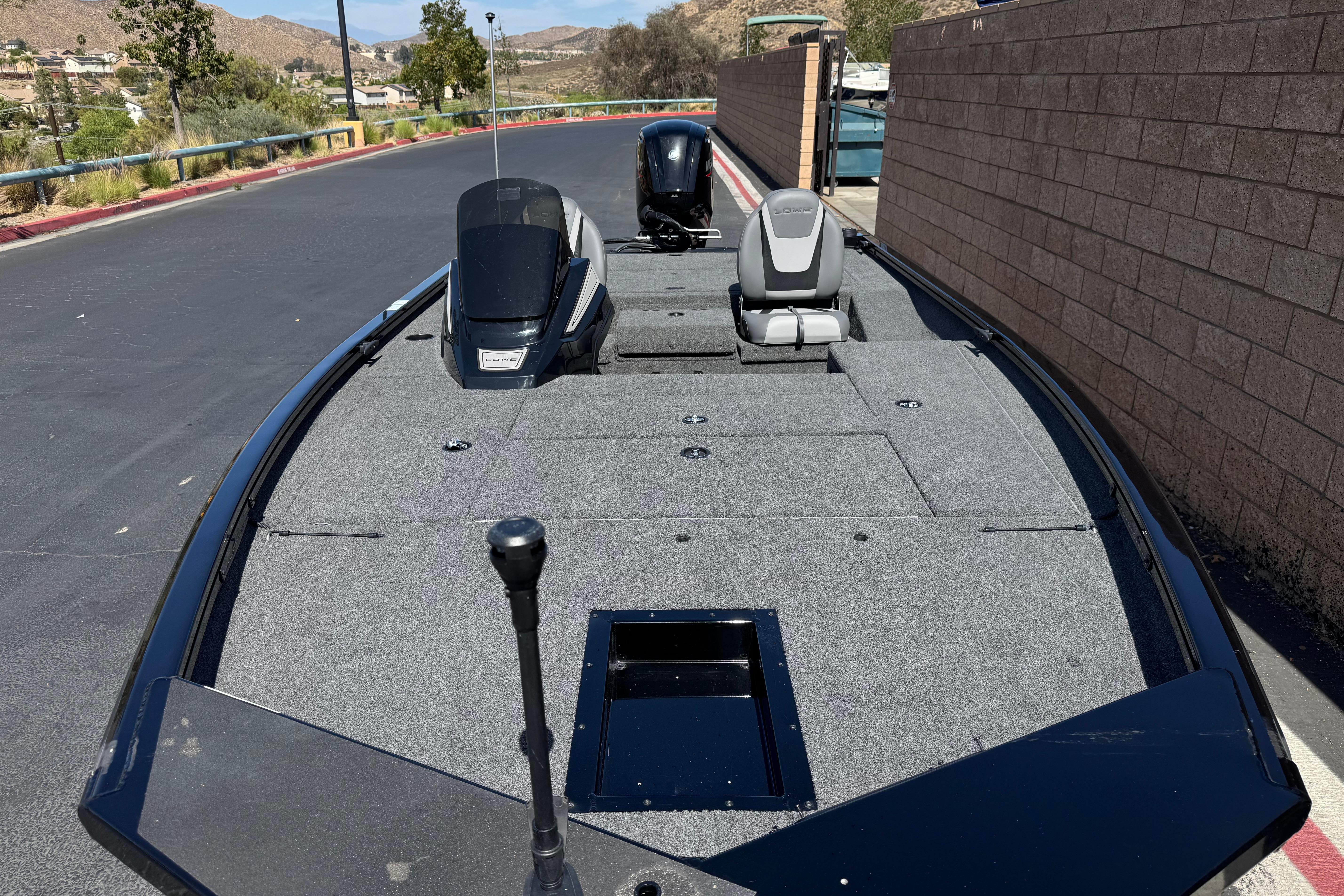 2024 Lowe Stinger 175 boat with sleek design, parked on a paved road.
