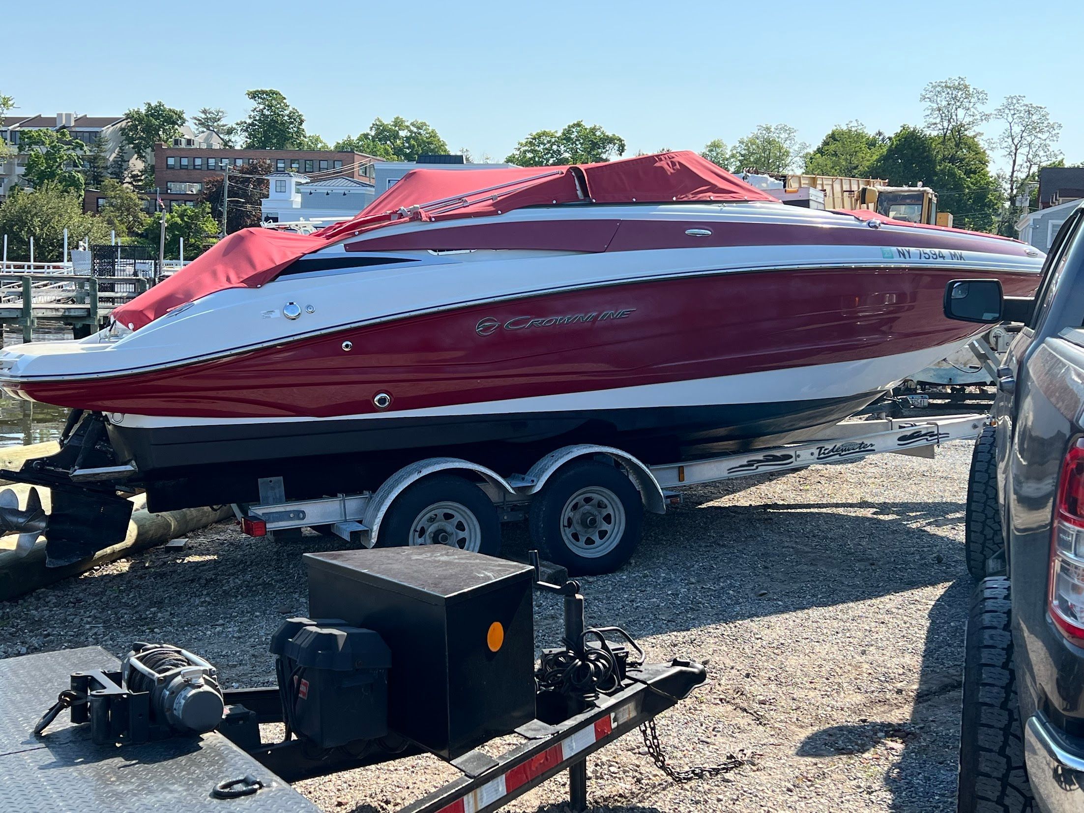 2014 Crownline Eclipse E2 boat on trailer, red and white.