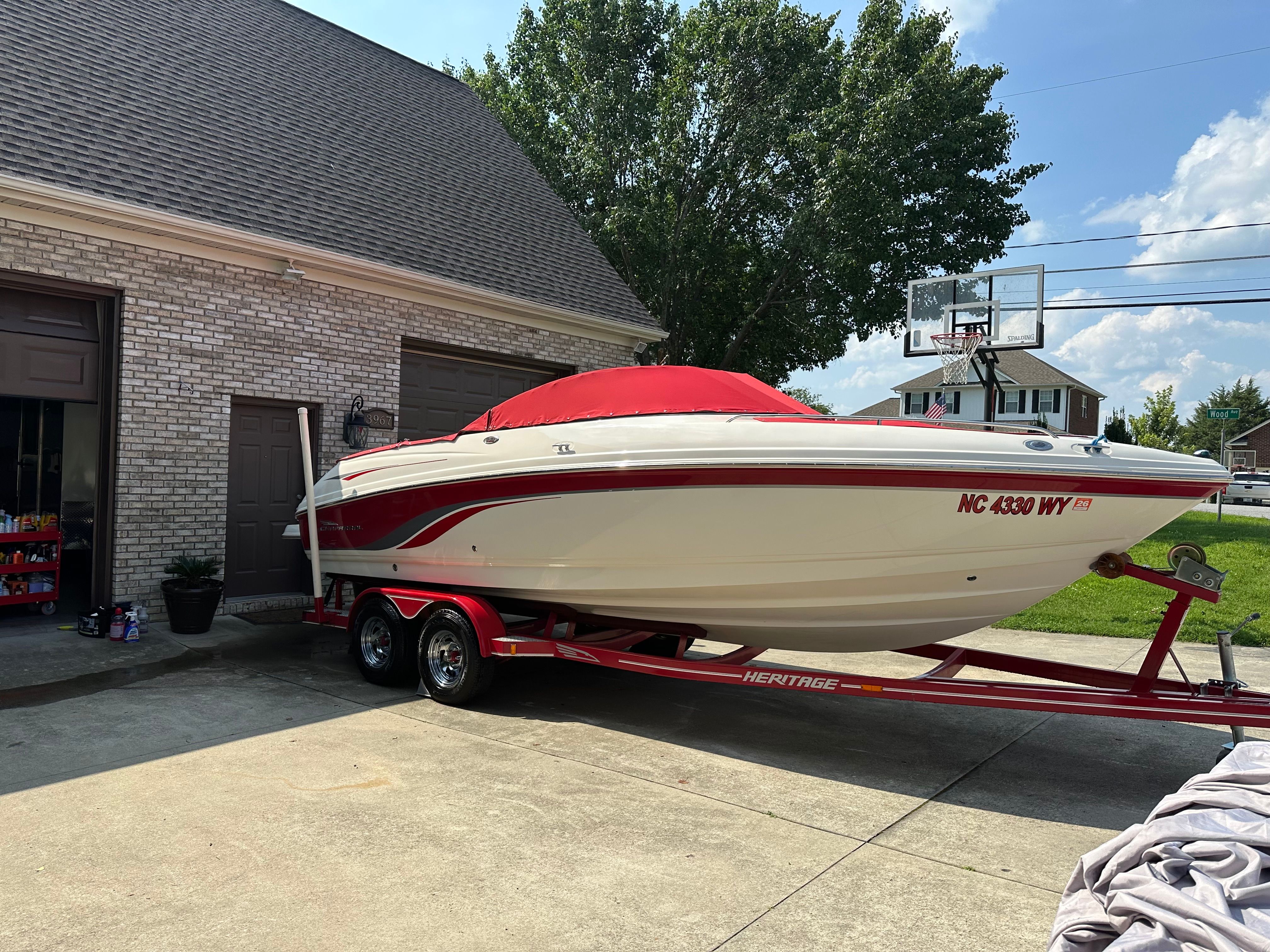2000 Chaparral 230 SSi boat on trailer in driveway.