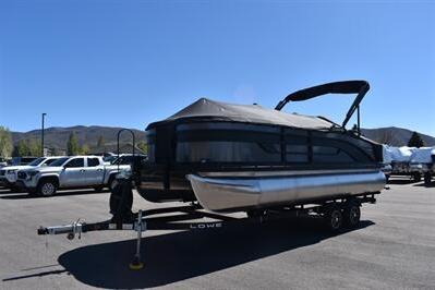 2026 Lowe SF 212 Sport Fish pontoon boat on trailer in parking lot.