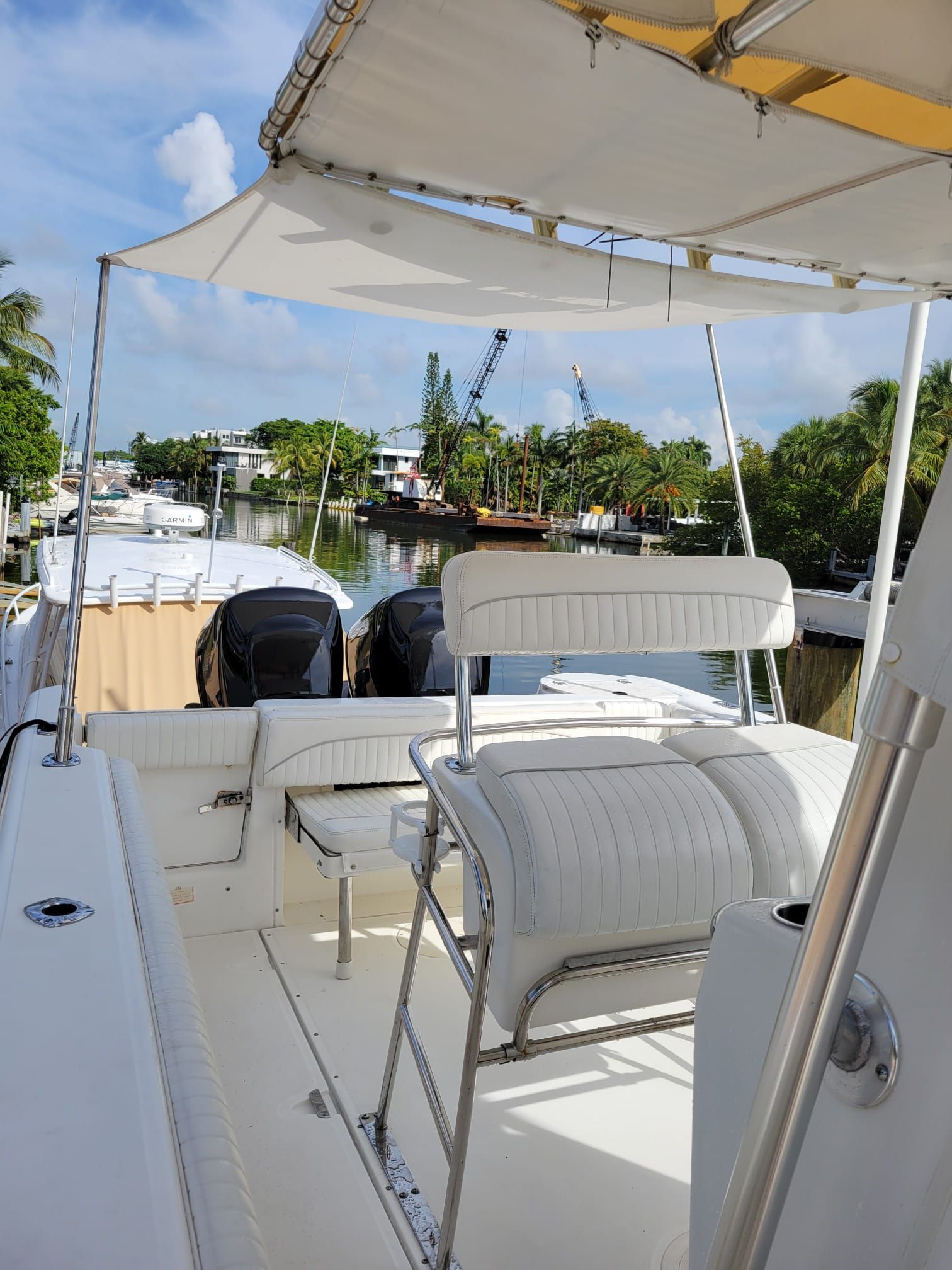 Boston Whaler 26 Outrage 2001 on calm water with palm trees in background.