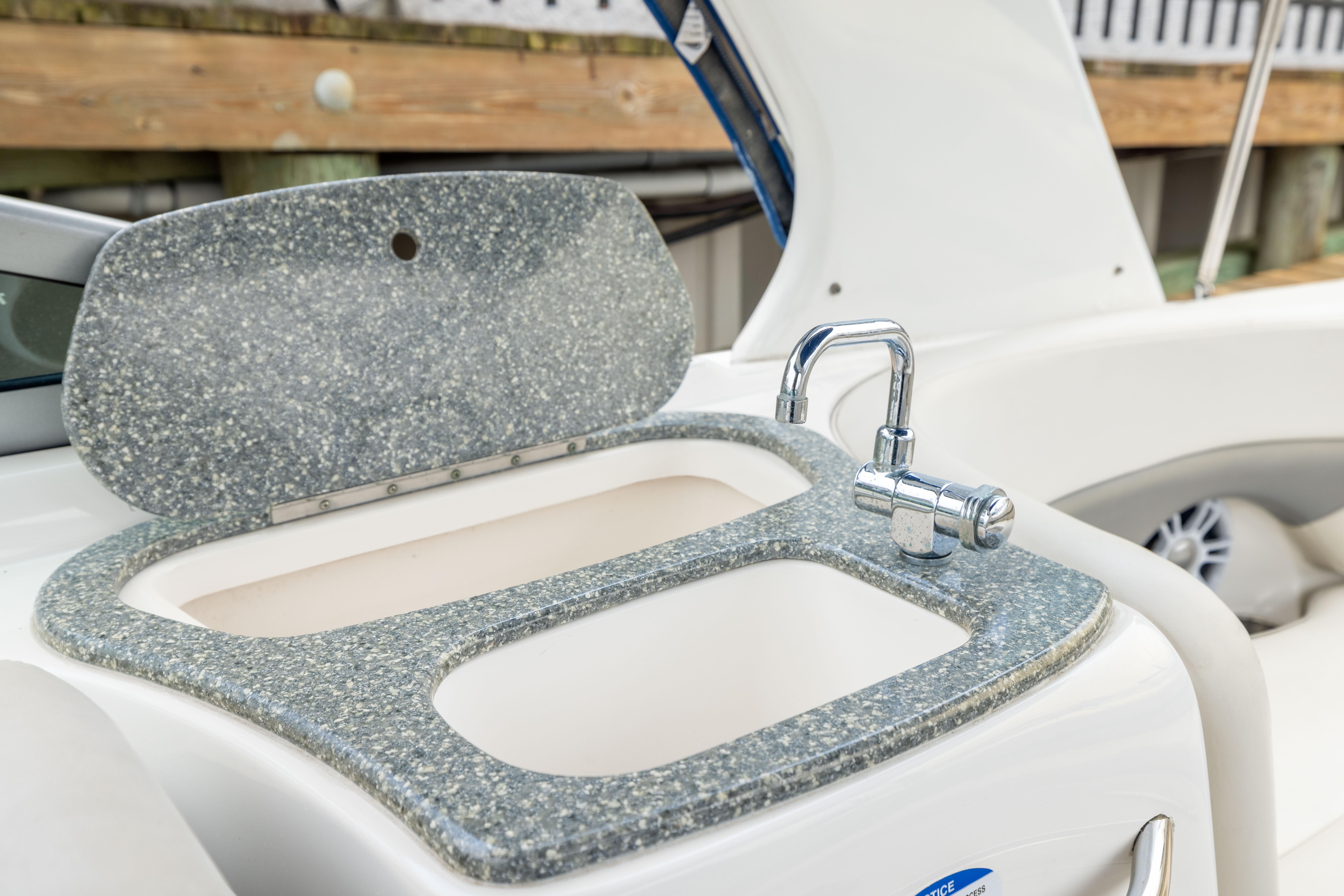 2008 Chaparral 256 SSi boat sink with granite countertop and chrome faucet.