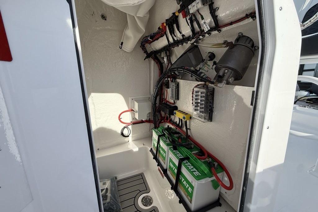 2026 Tidewater 198 CC Adventure boat electrical compartment with batteries and wiring.