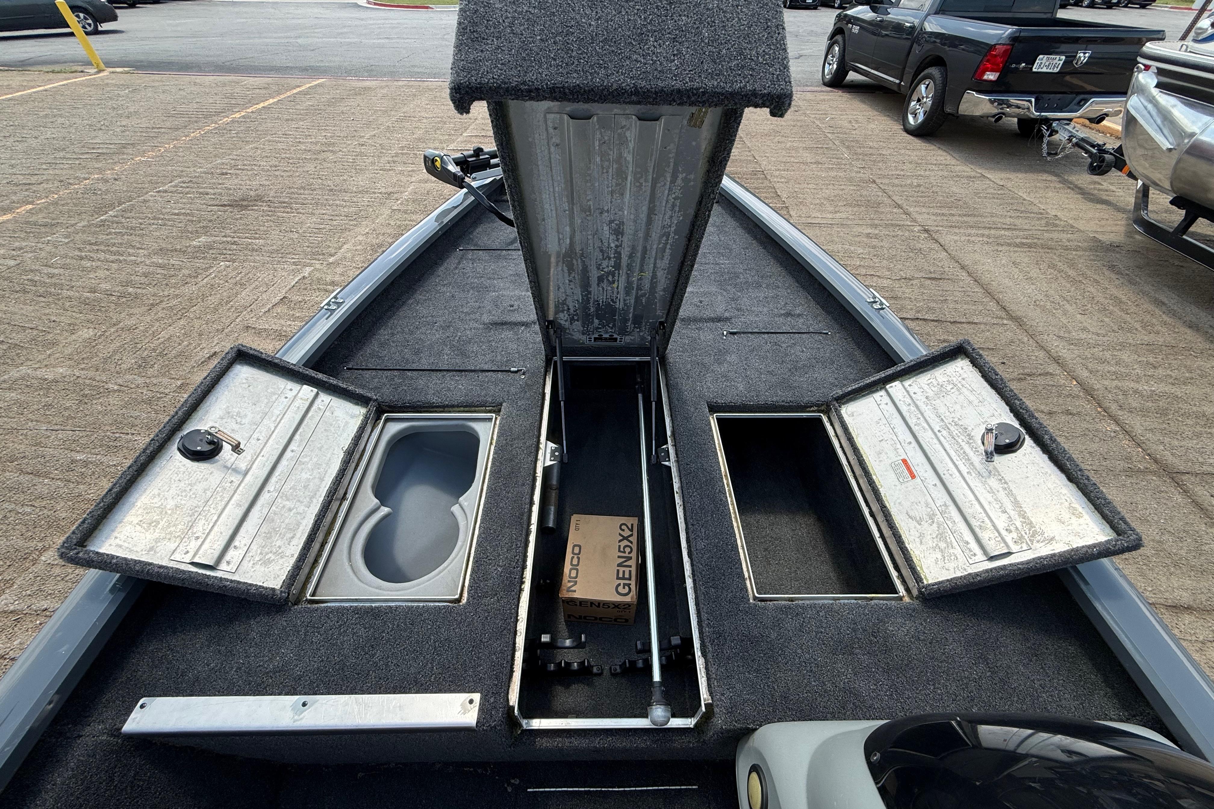 2015 Tracker Pro Team 190 TX boat with open storage compartments on deck.