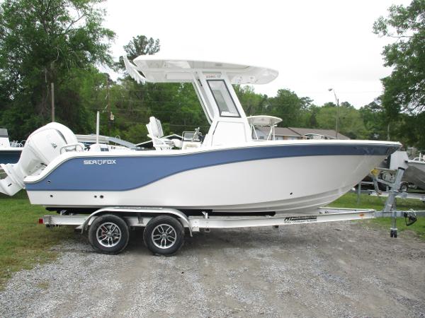 2025 Sea Fox 228 Commander boat on trailer, parked outdoors.
