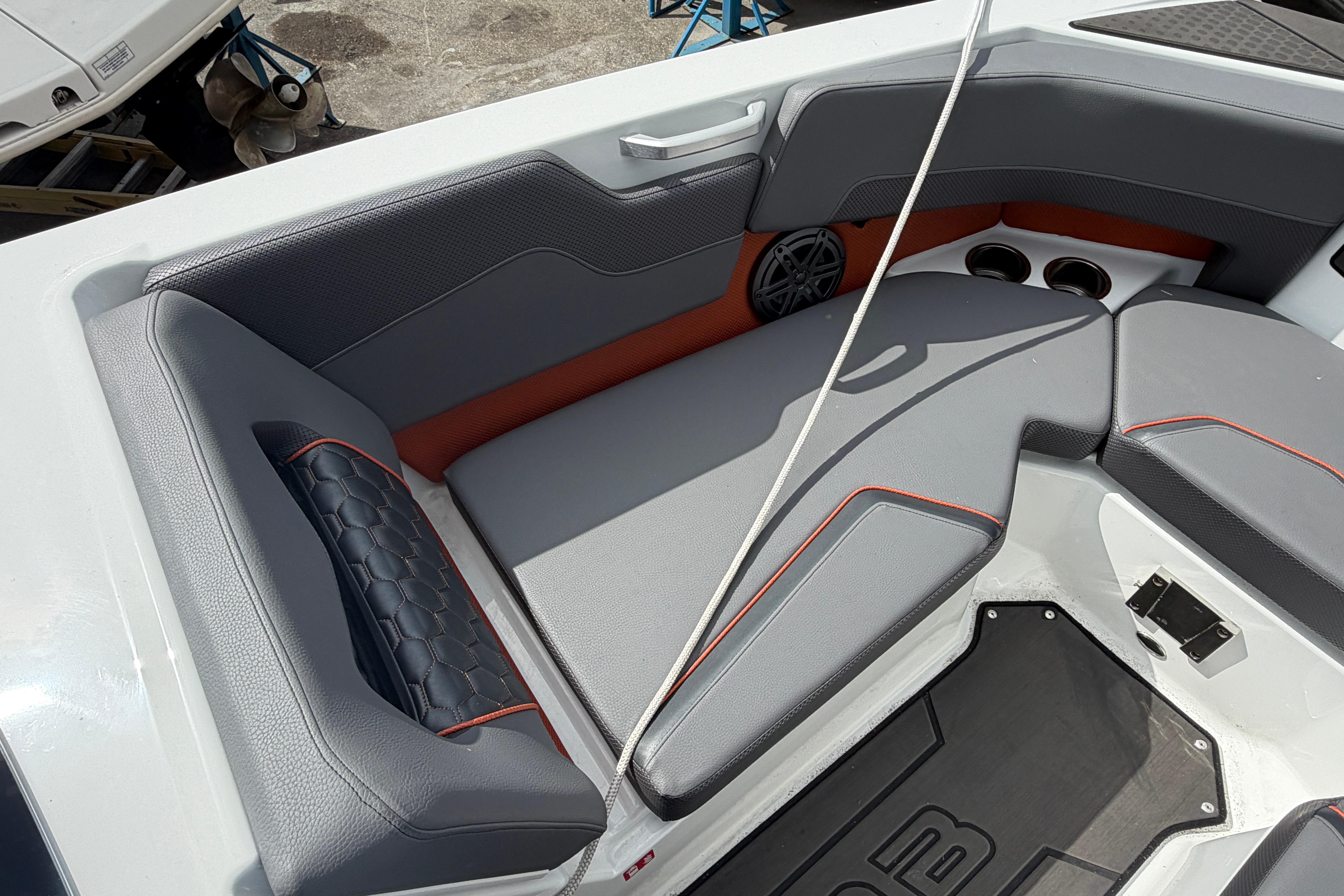 Interior seating of 2026 Scarab 235 LX boat with gray and orange accents.