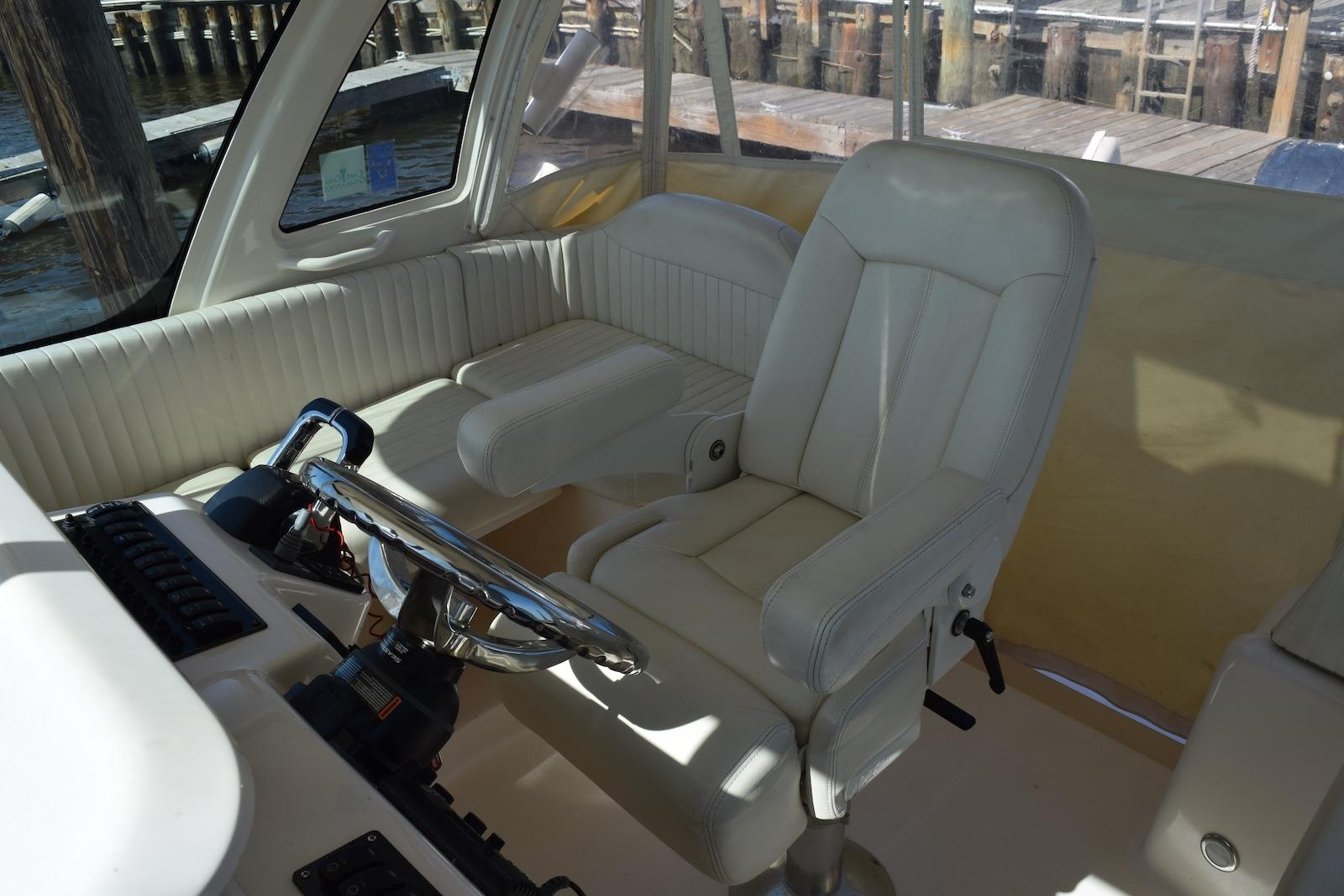 Interior of 2013 Grady-White Express 330 boat with steering wheel and seating.