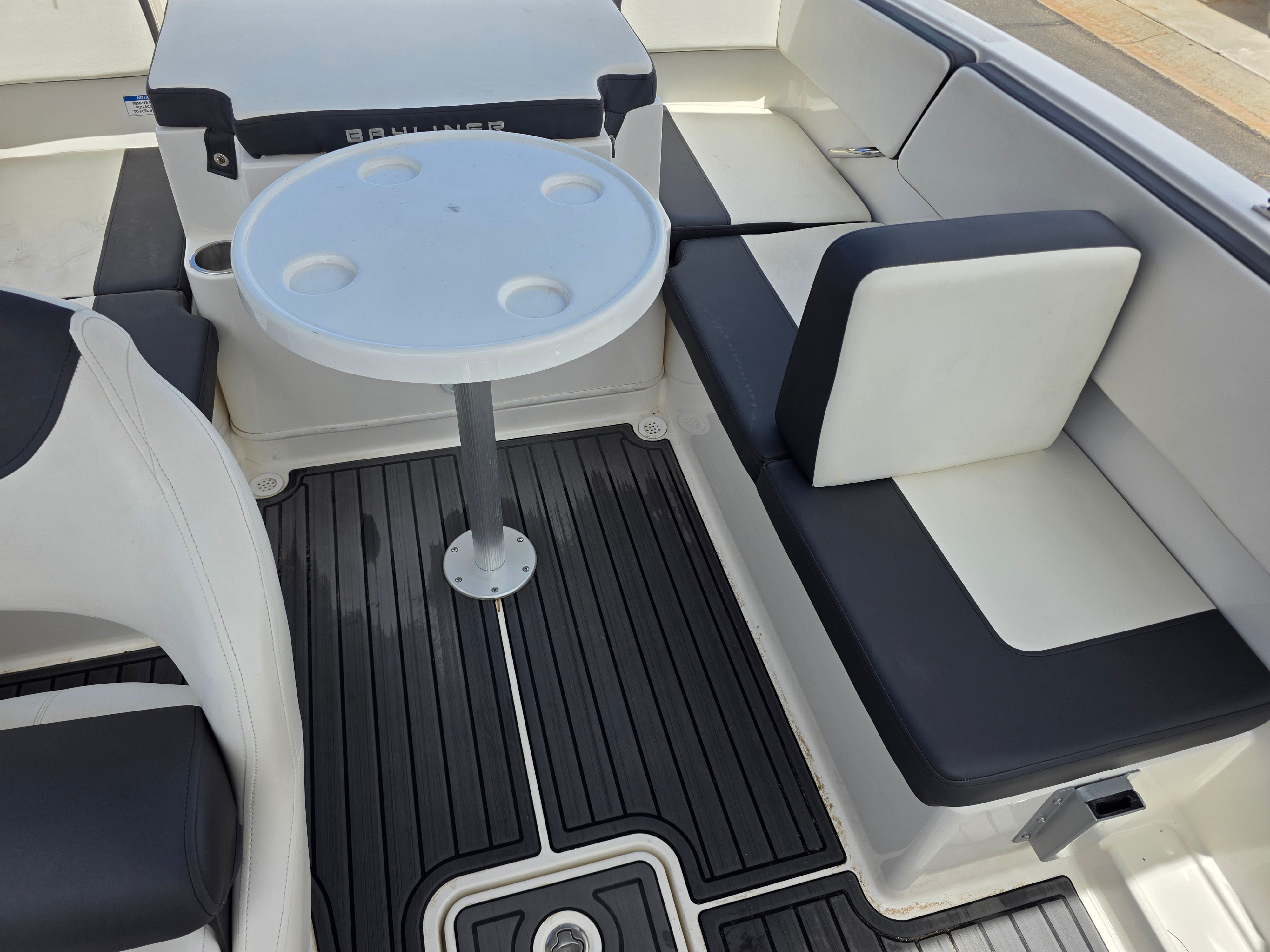 Interior of a Bayliner VR4 Bowrider with seating area and table.