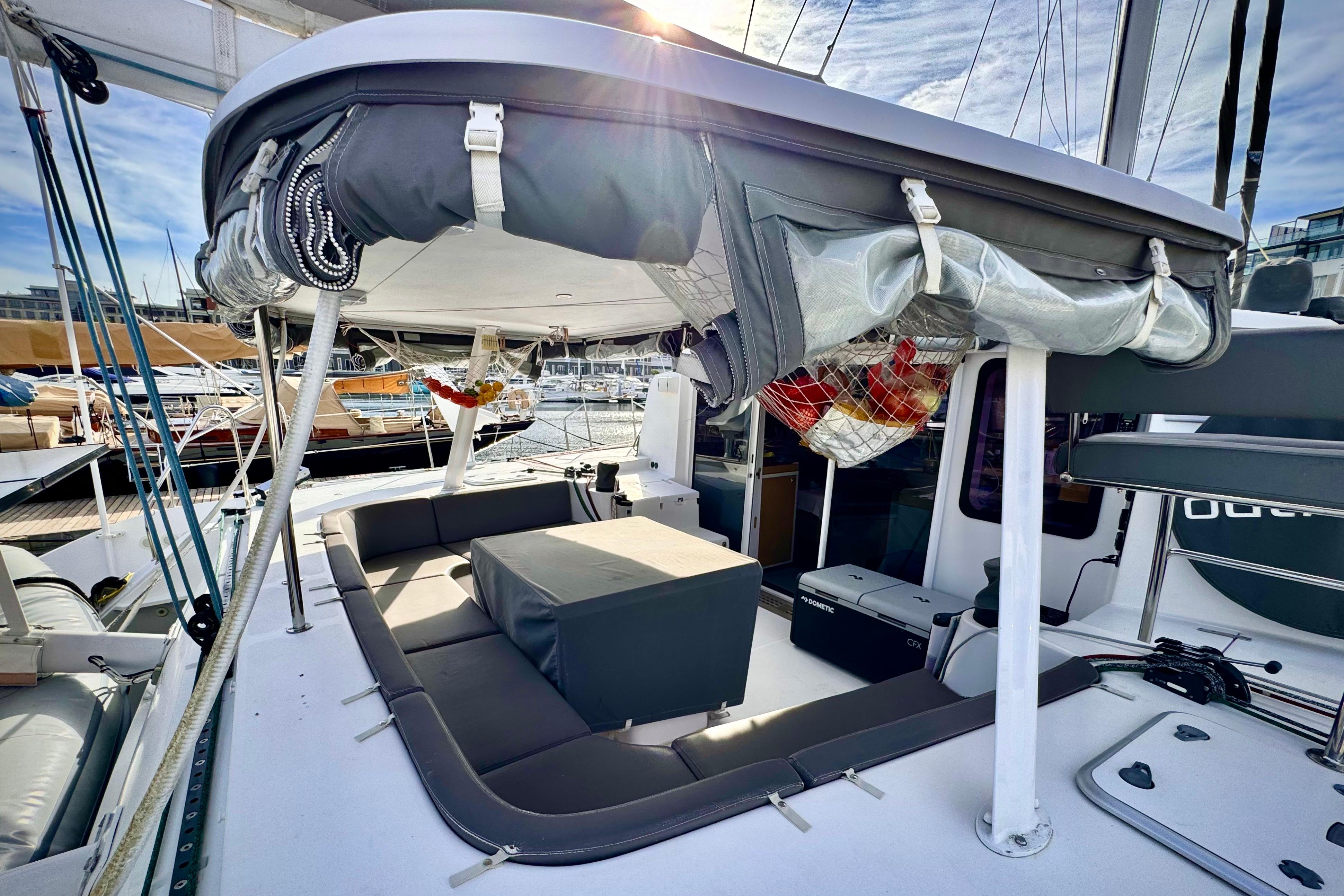 2017 Outremer 51 catamaran deck with seating and covered cockpit area.