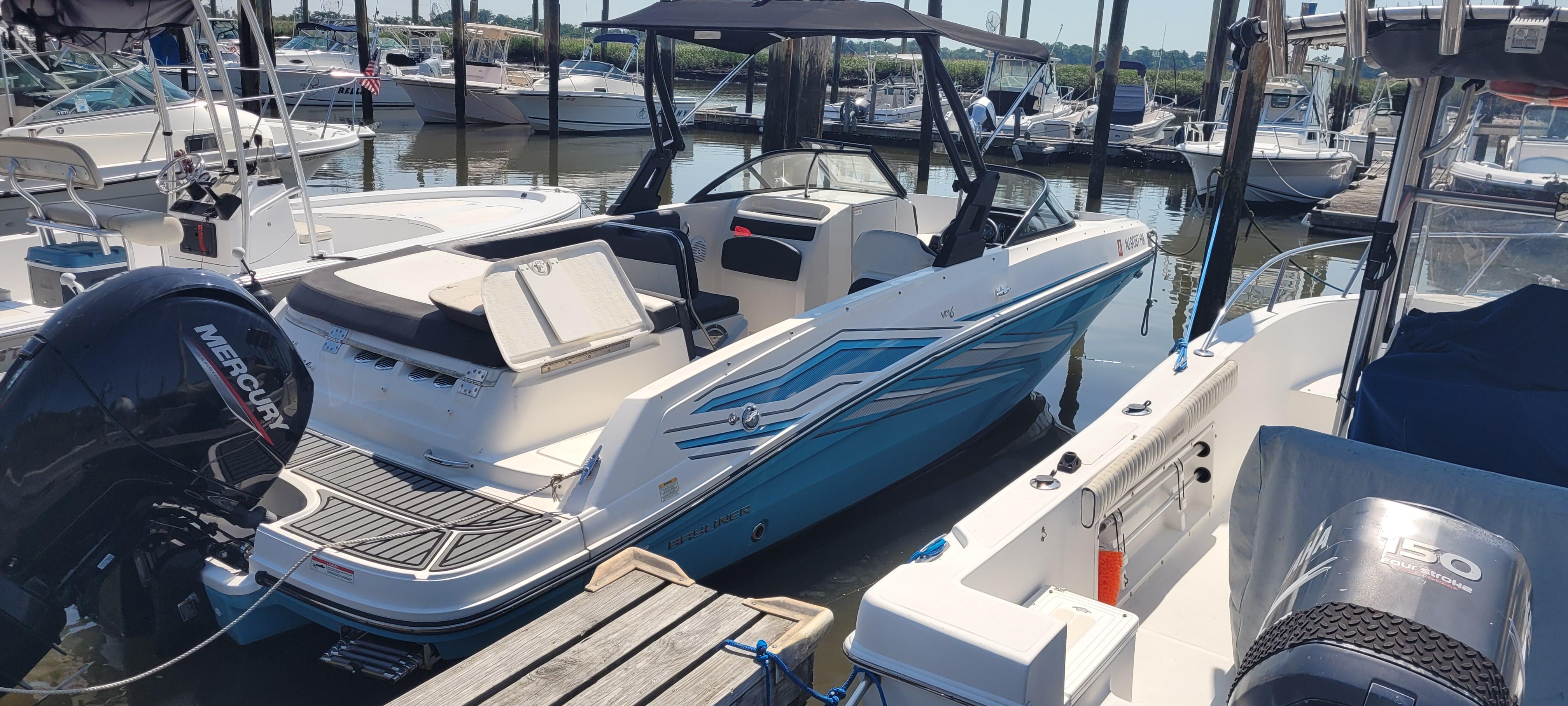 2020 Bayliner VR5 Bowrider OB docked, featuring sleek design and powerful Mercury outboard engine.