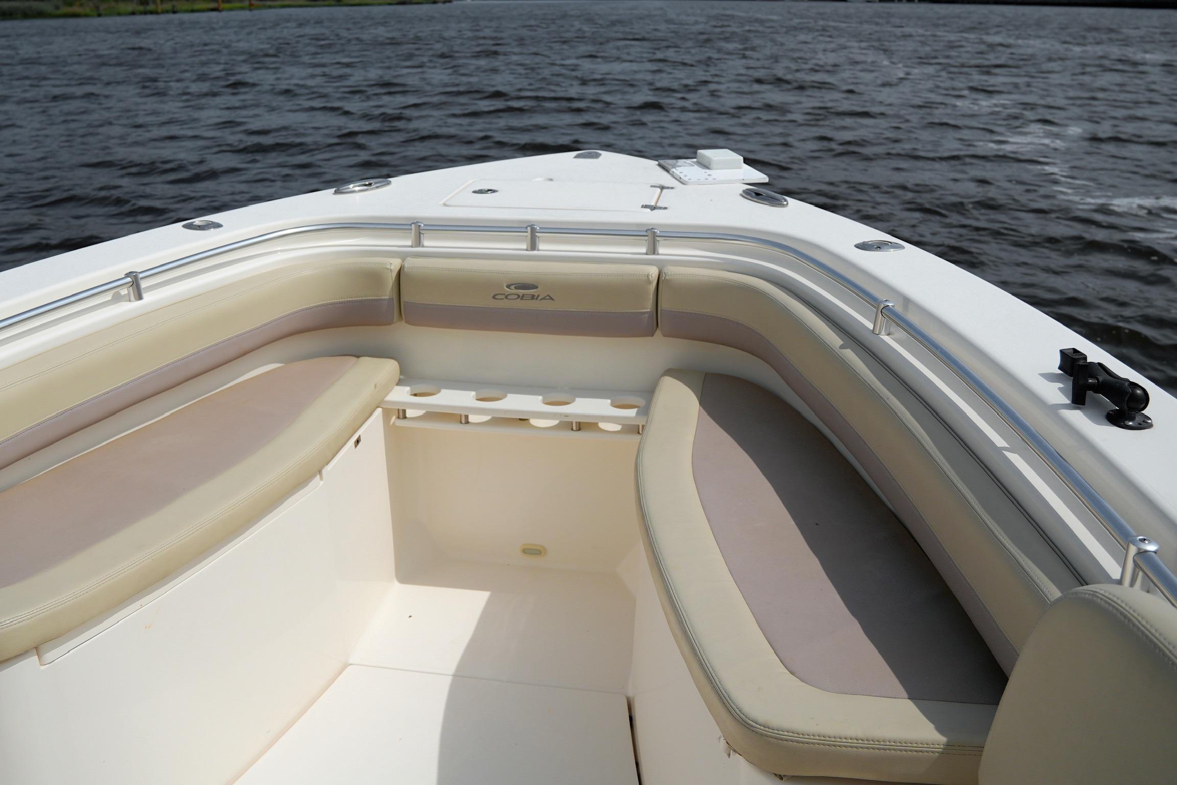 2016 Cobia 296 Center Console boat interior with cushioned seating on open water.