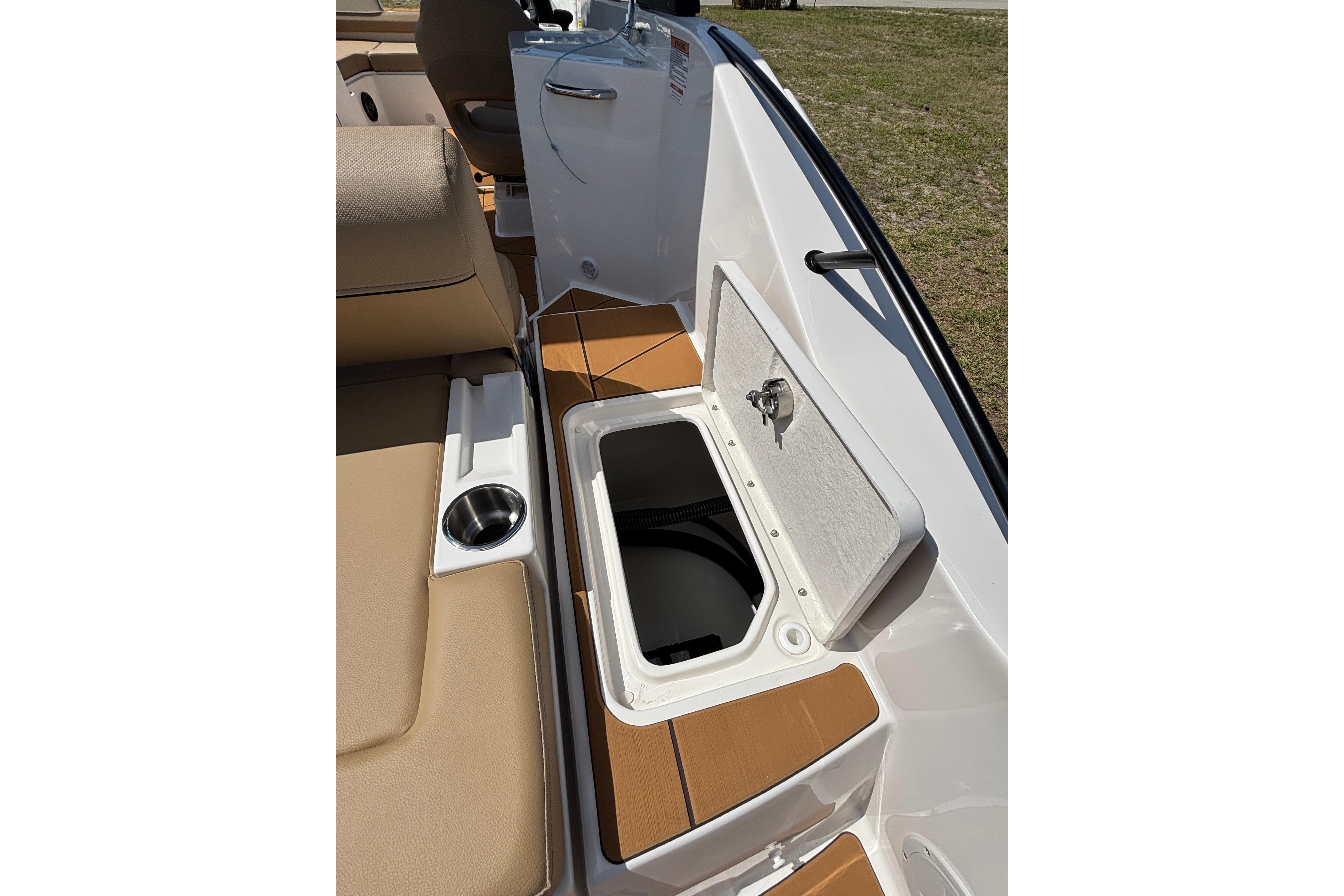 2026 Bayliner D22 boat interior with open storage compartment and cup holder.