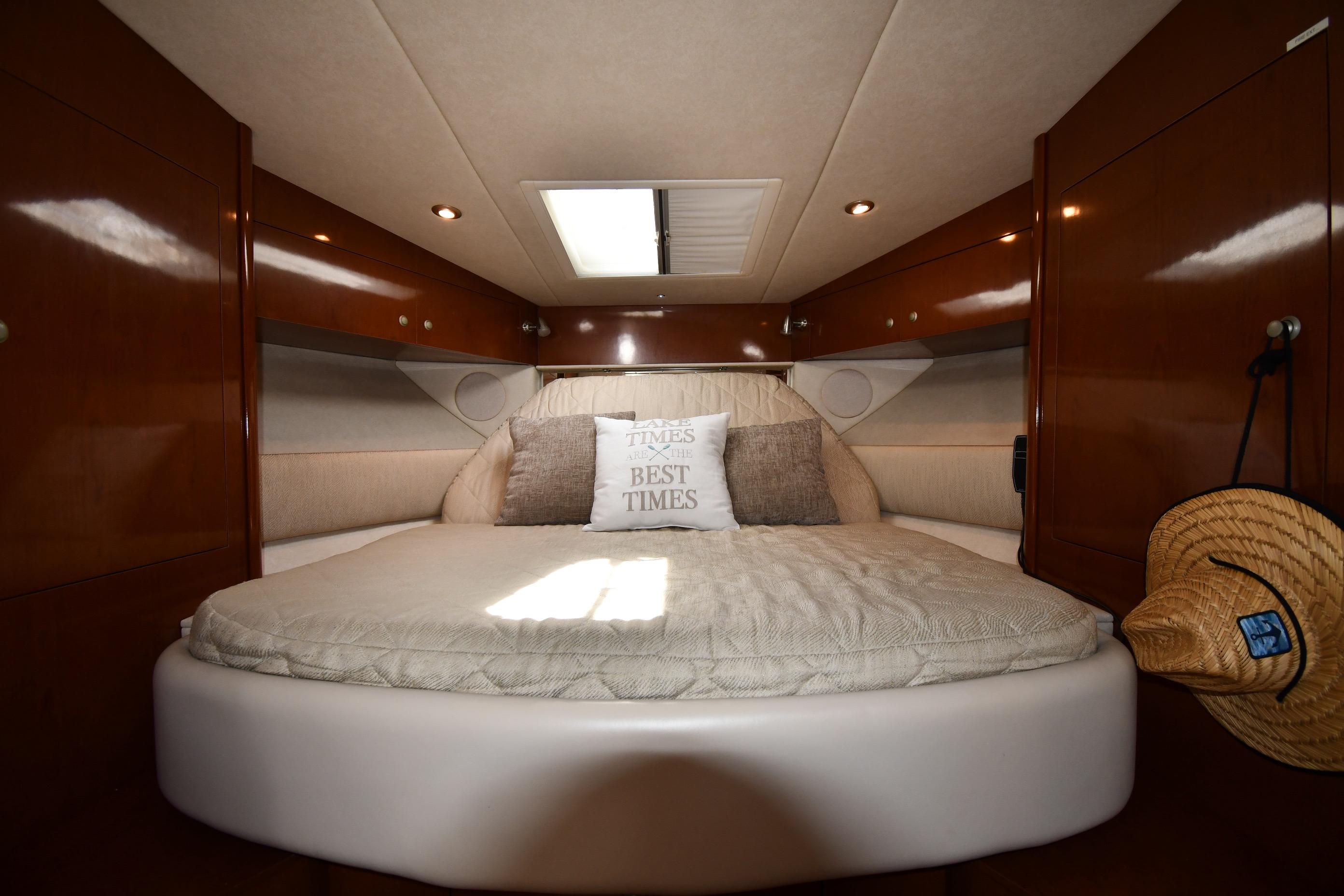 Luxurious cabin interior of 2008 Sea Ray Sundancer 350 yacht with cozy bedding.