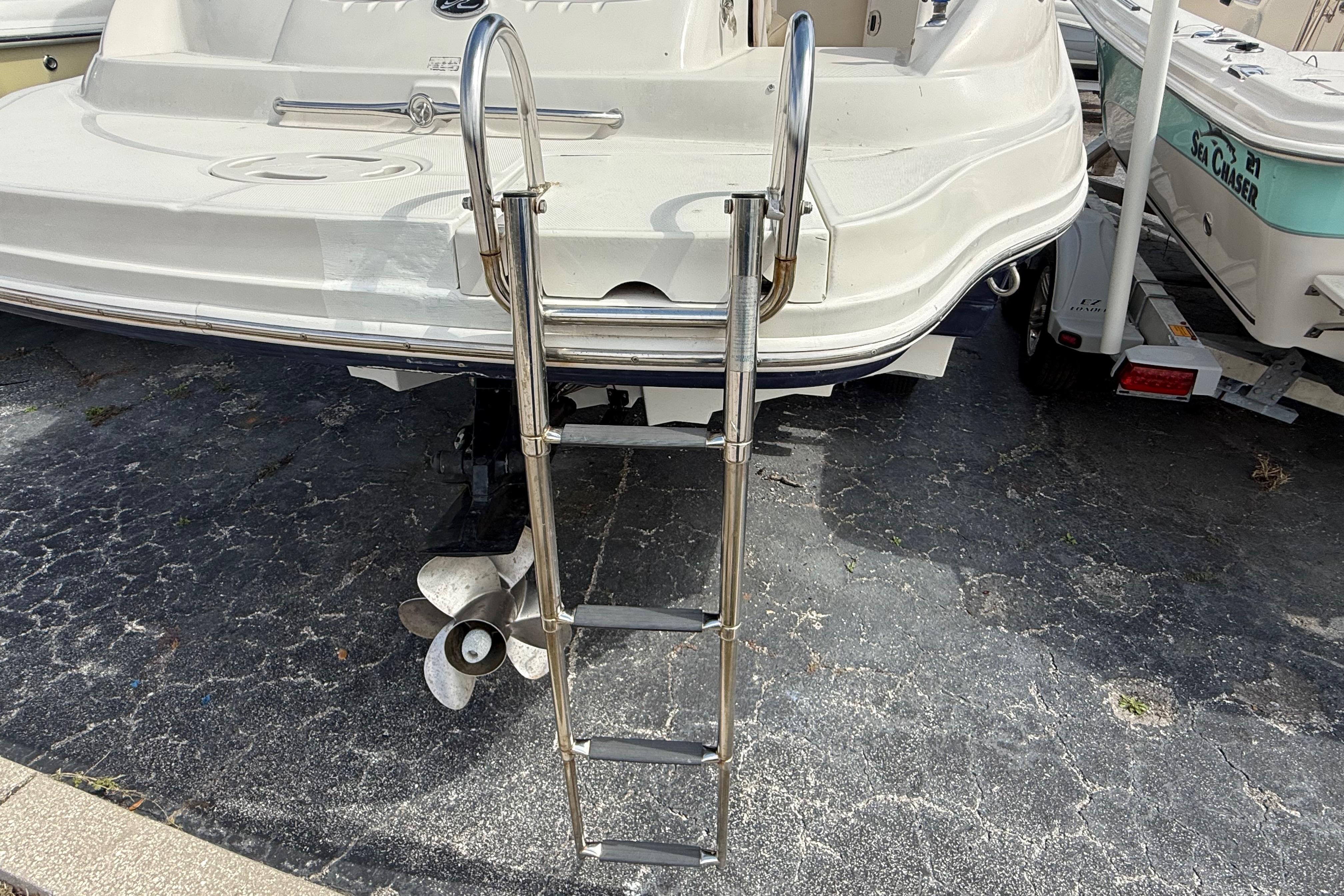 Rear view of 2005 Sea Ray 220 Sundeck with ladder and propeller.
