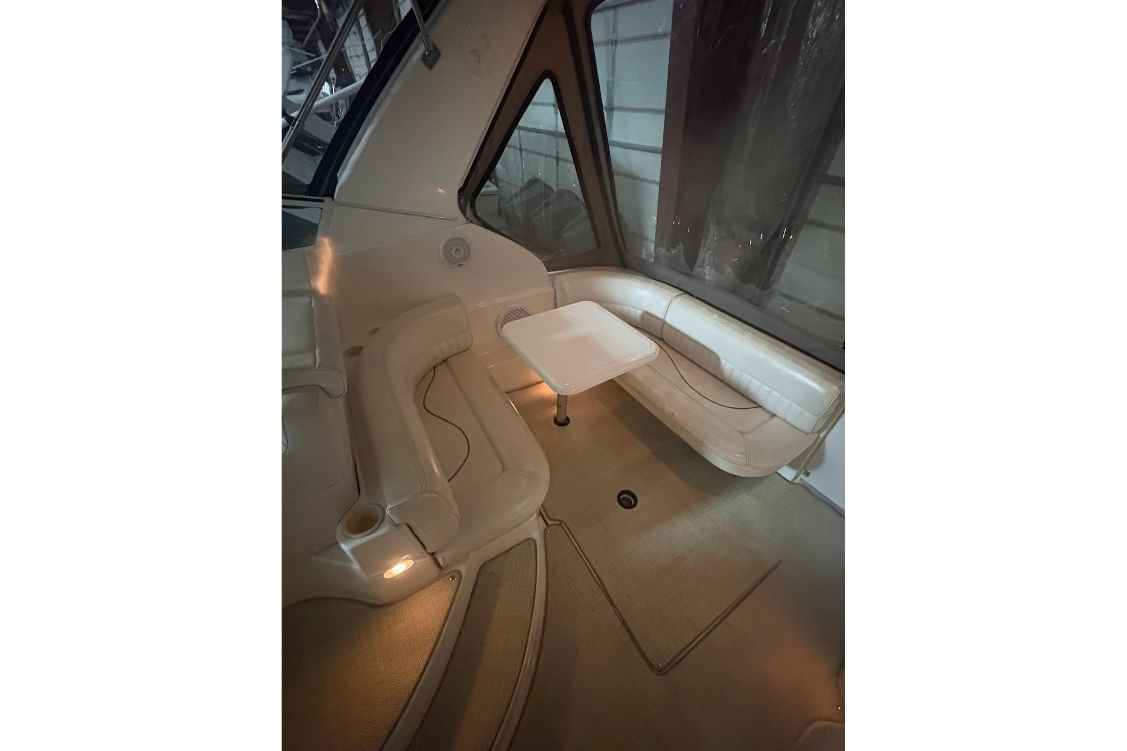 Interior of 2000 Cruisers Yachts 2870 Express, featuring seating and a small table.