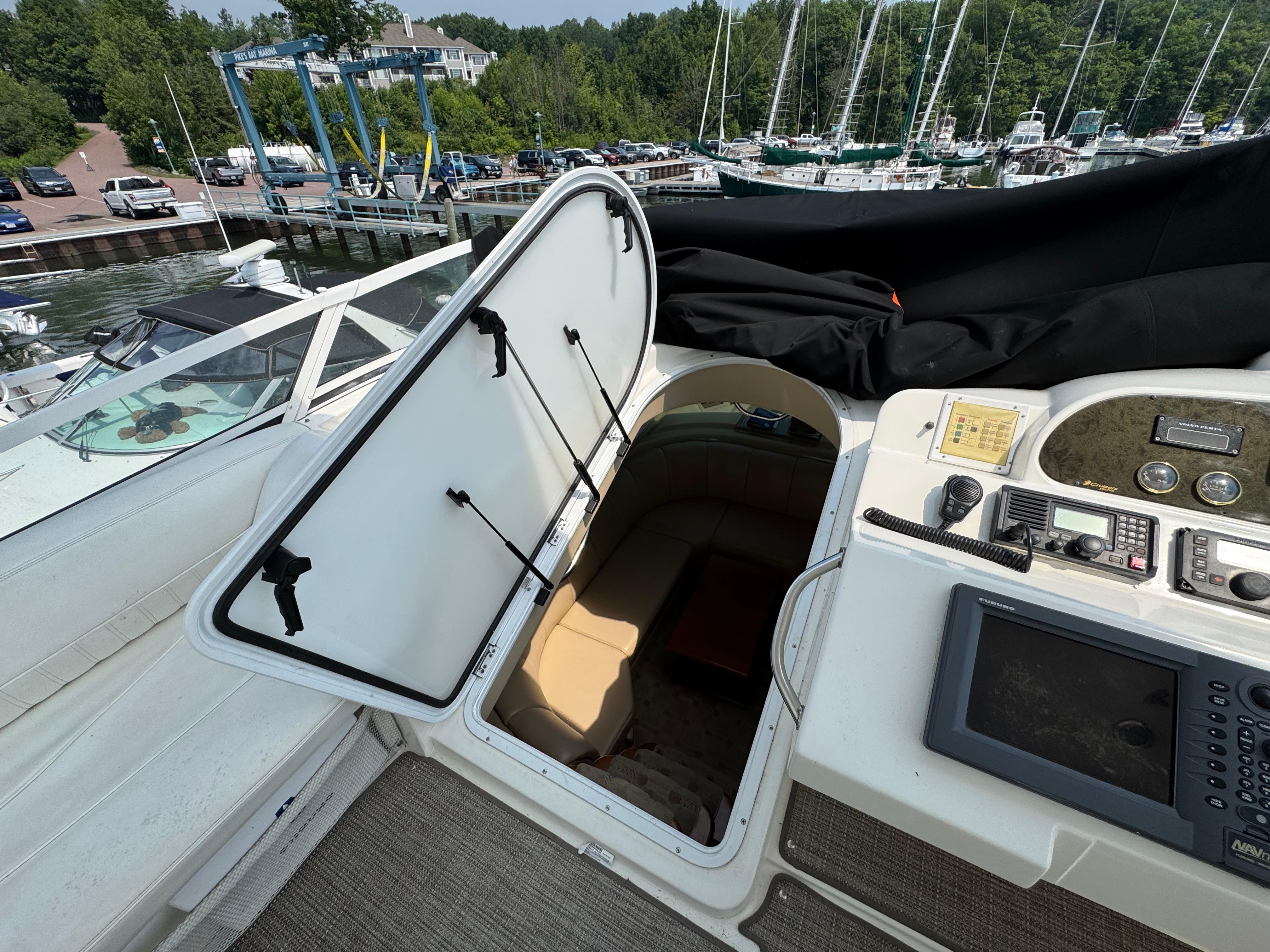 2003 Cruisers Yachts 5000 Sedan Sport interior view with open hatch and control panel.