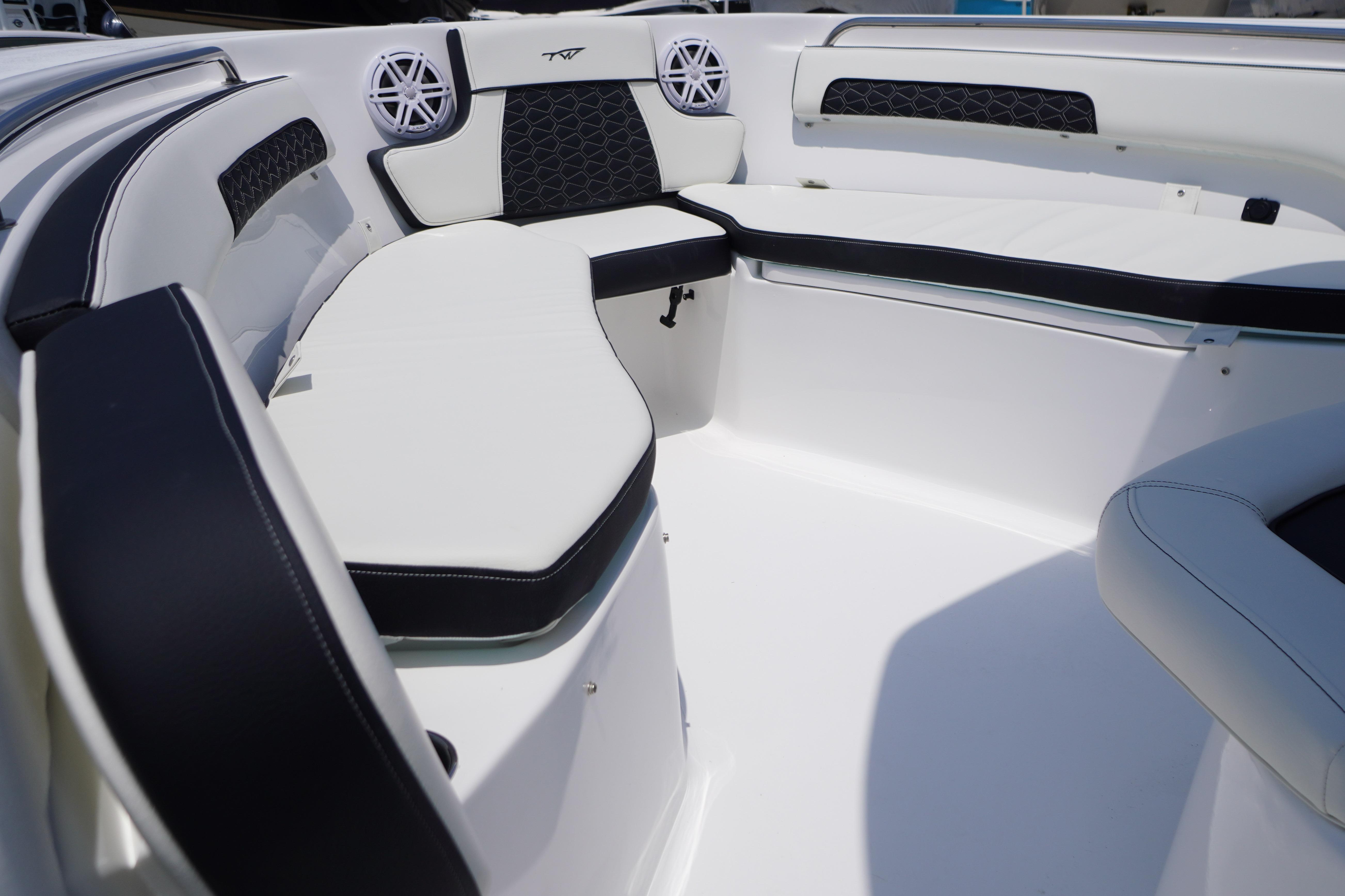 2027 Tidewater 220 CC Adventure boat interior with cushioned seating and speaker system.