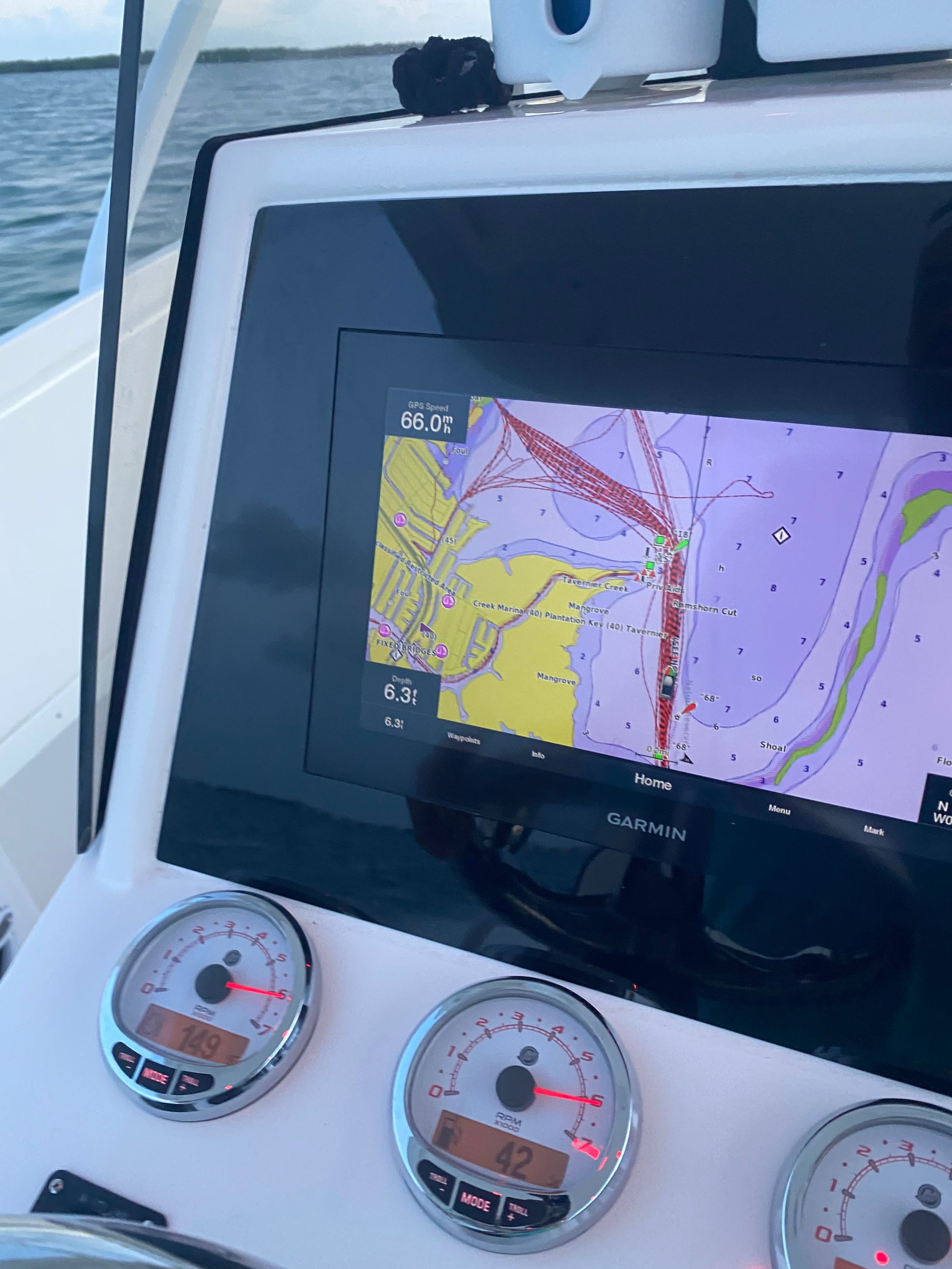 The image shows the navigation system of a 2011 Intrepid 37 boat with a Garmin map display.