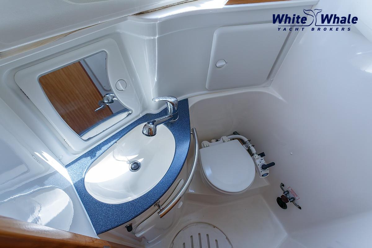 Bathroom interior of 2006 Bavaria Cruiser 30 yacht with sink and toilet.