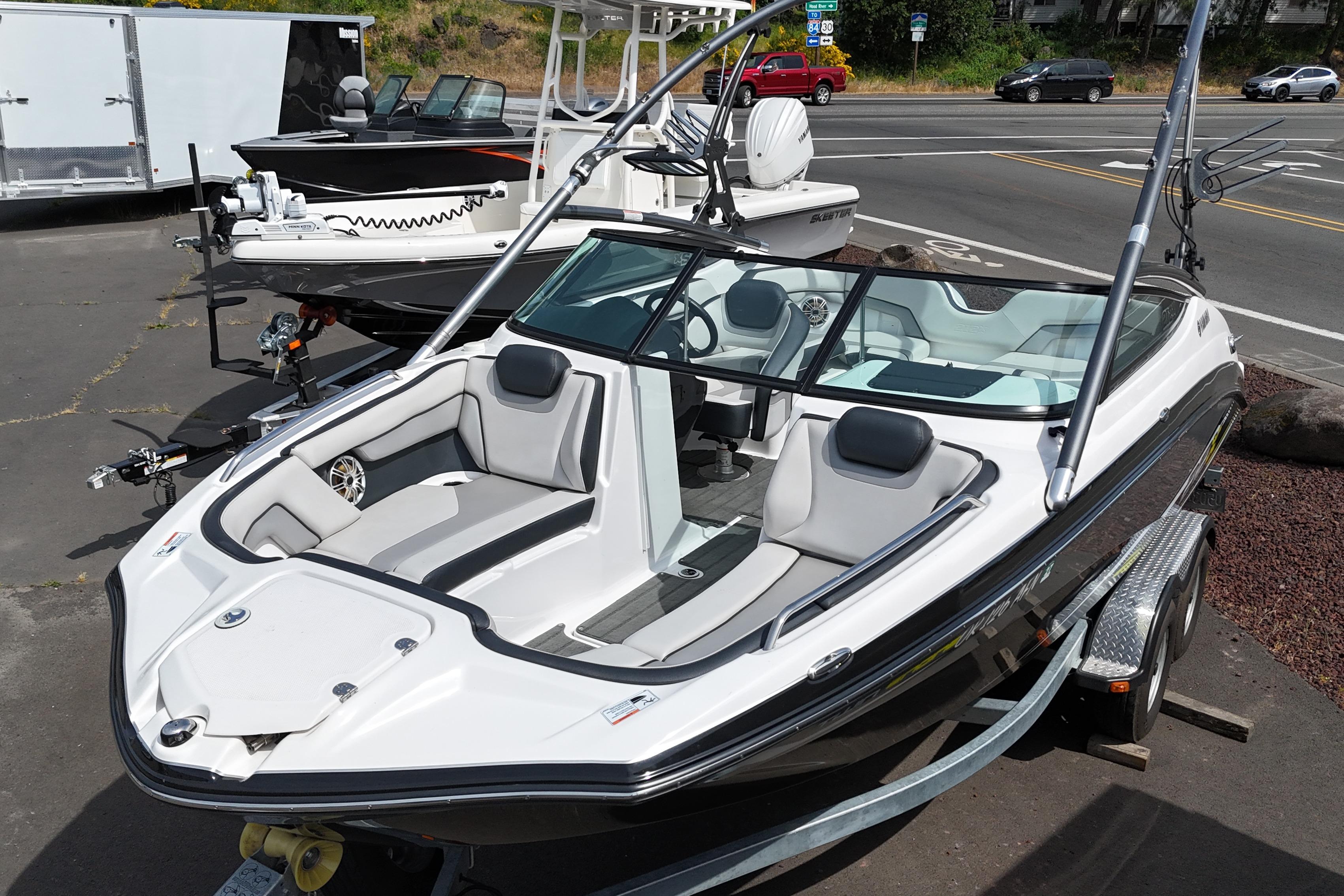 2016 Yamaha Boats 212X on trailer, sleek design, parked outdoors.