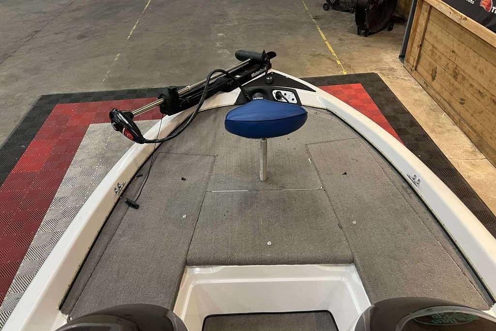 2005 Nitro NX 750 boat interior with trolling motor and blue seat.