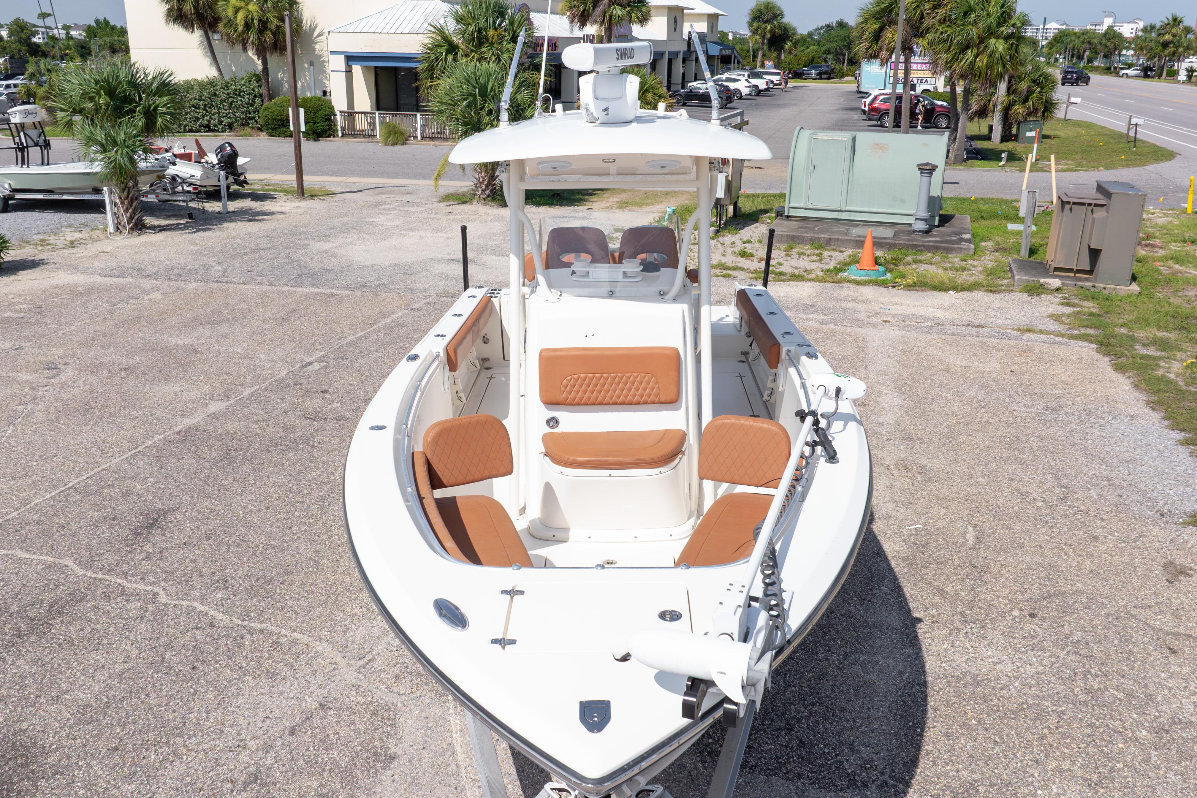 2017 Cobia 261 Center Console boat with tan seating, parked outdoors.
