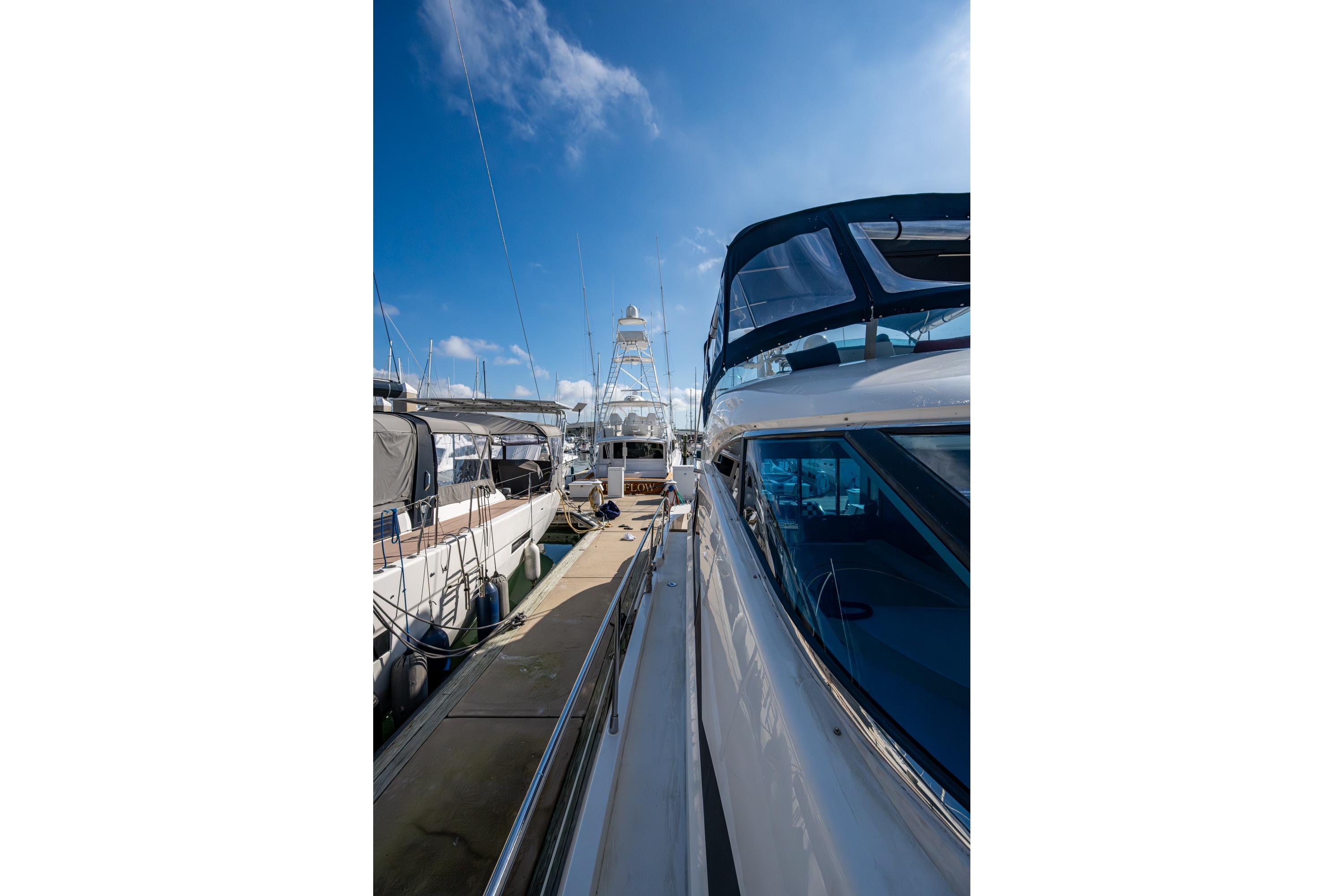 Fairline Squadron 52 yacht docked at marina, clear blue sky, 2000 model.