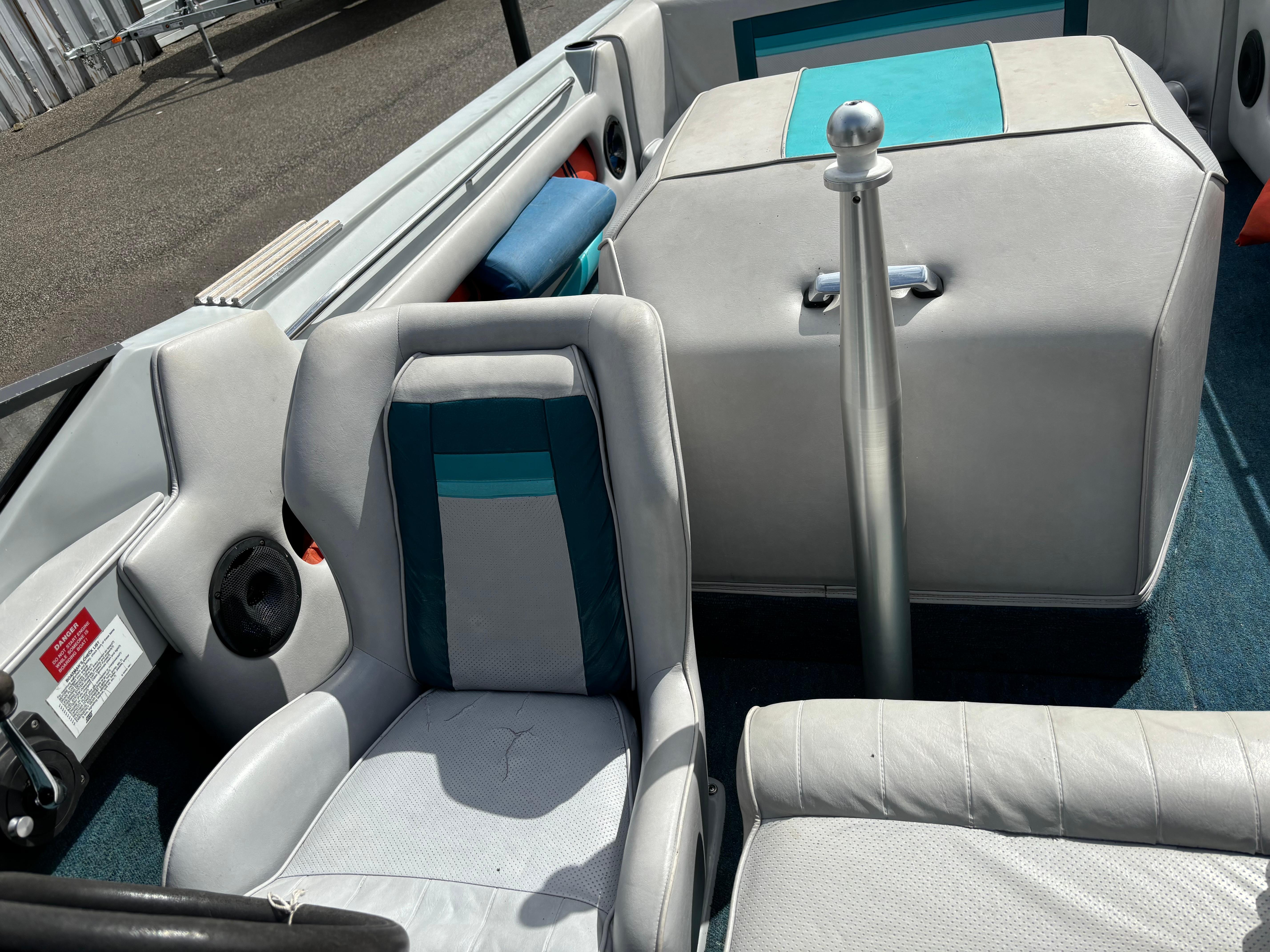 1989 MasterCraft ProStar 190 boat interior with white and teal seating and ski pylon.