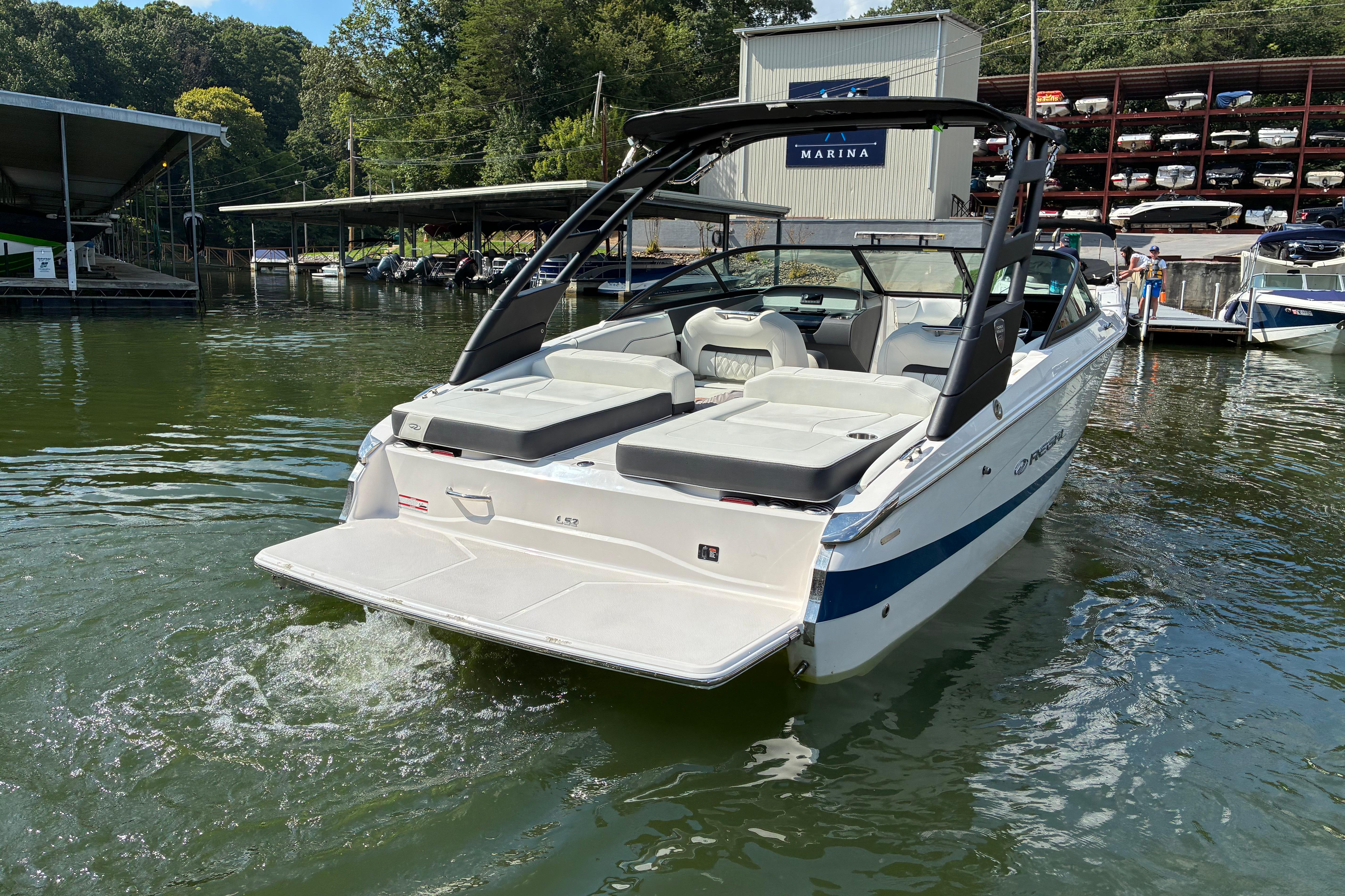 2025 Regal LS2 boat docked at marina, featuring sleek design and spacious seating.