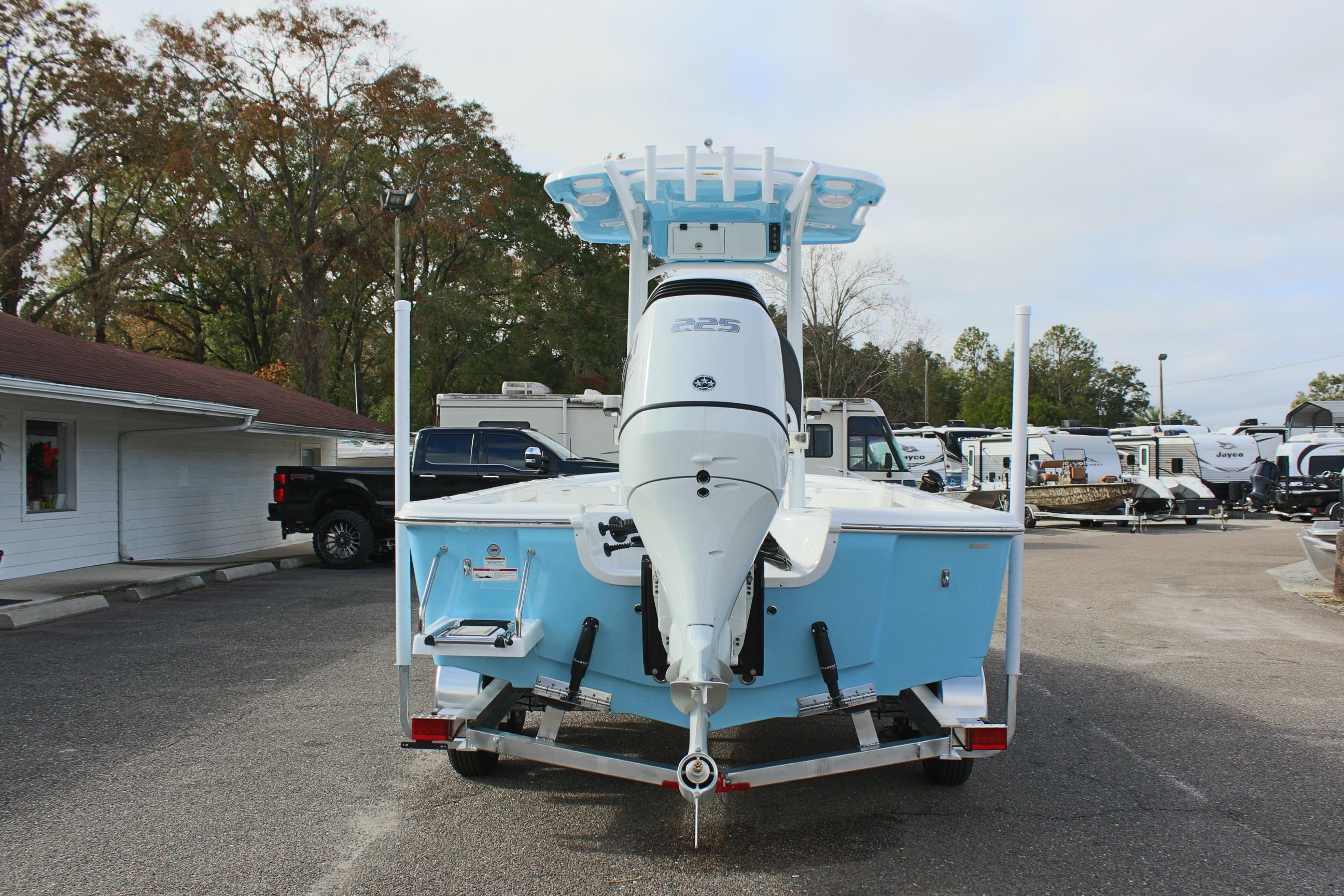 2025 Sea Pro 230 Bay boat on trailer, rear view, in outdoor setting.