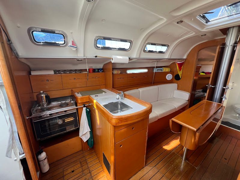 Interior of 2000 Beneteau First 40.7 yacht with kitchen and seating area.