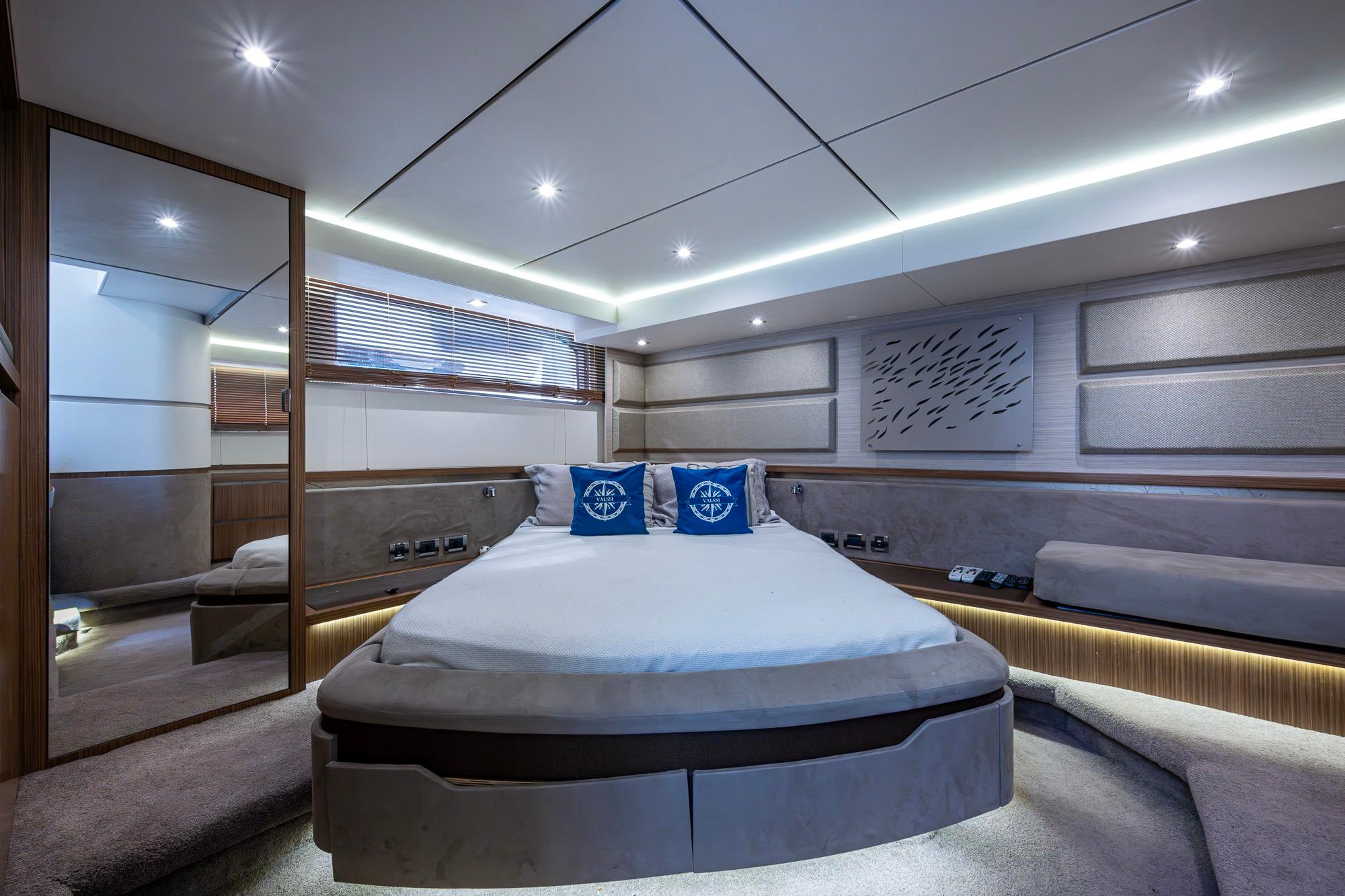 Luxurious interior of 2018 Sea Ray L550 Fly yacht bedroom with modern design.
