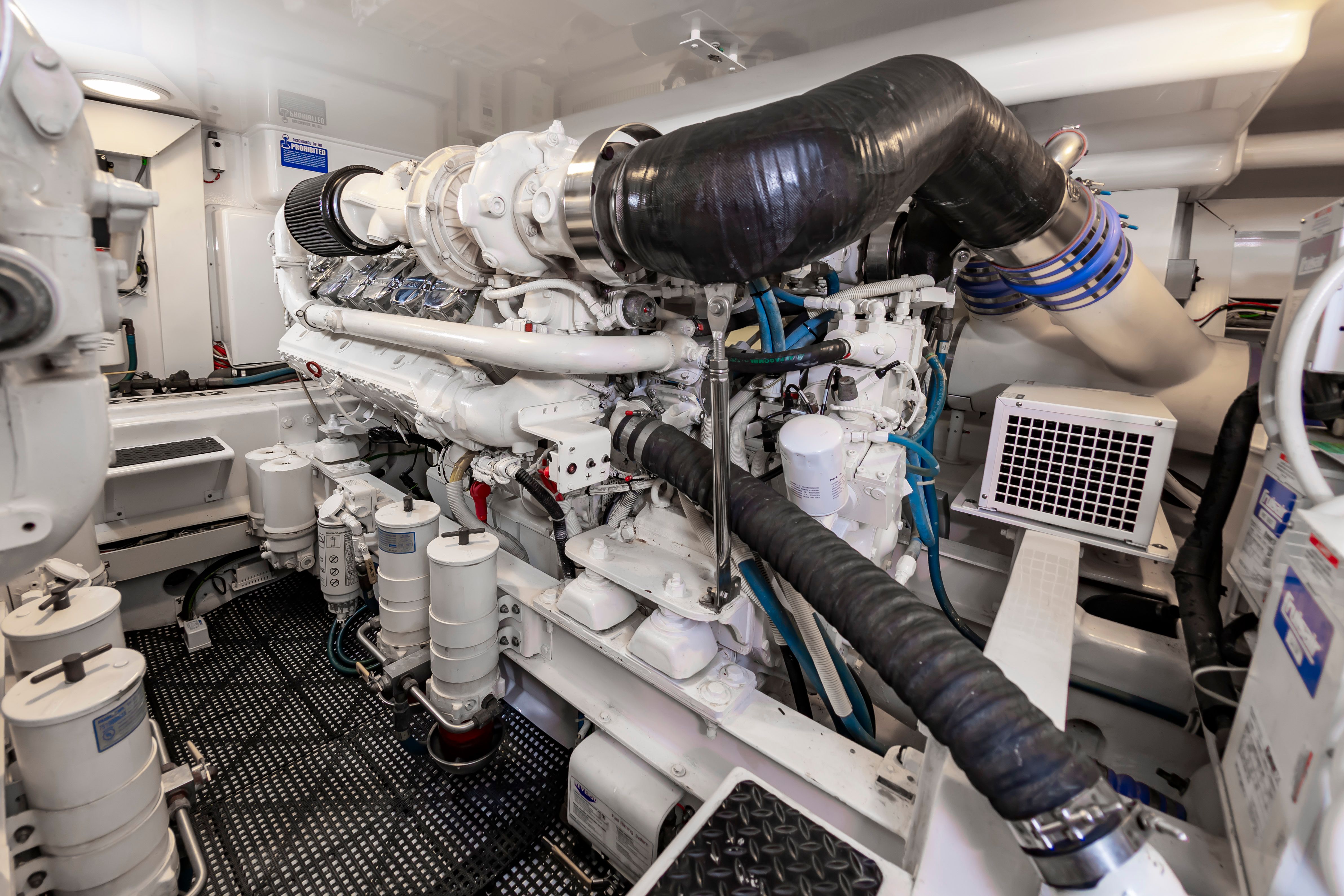 Engine room of 2010 Viking 52 Sport Coupe, showcasing complex machinery.