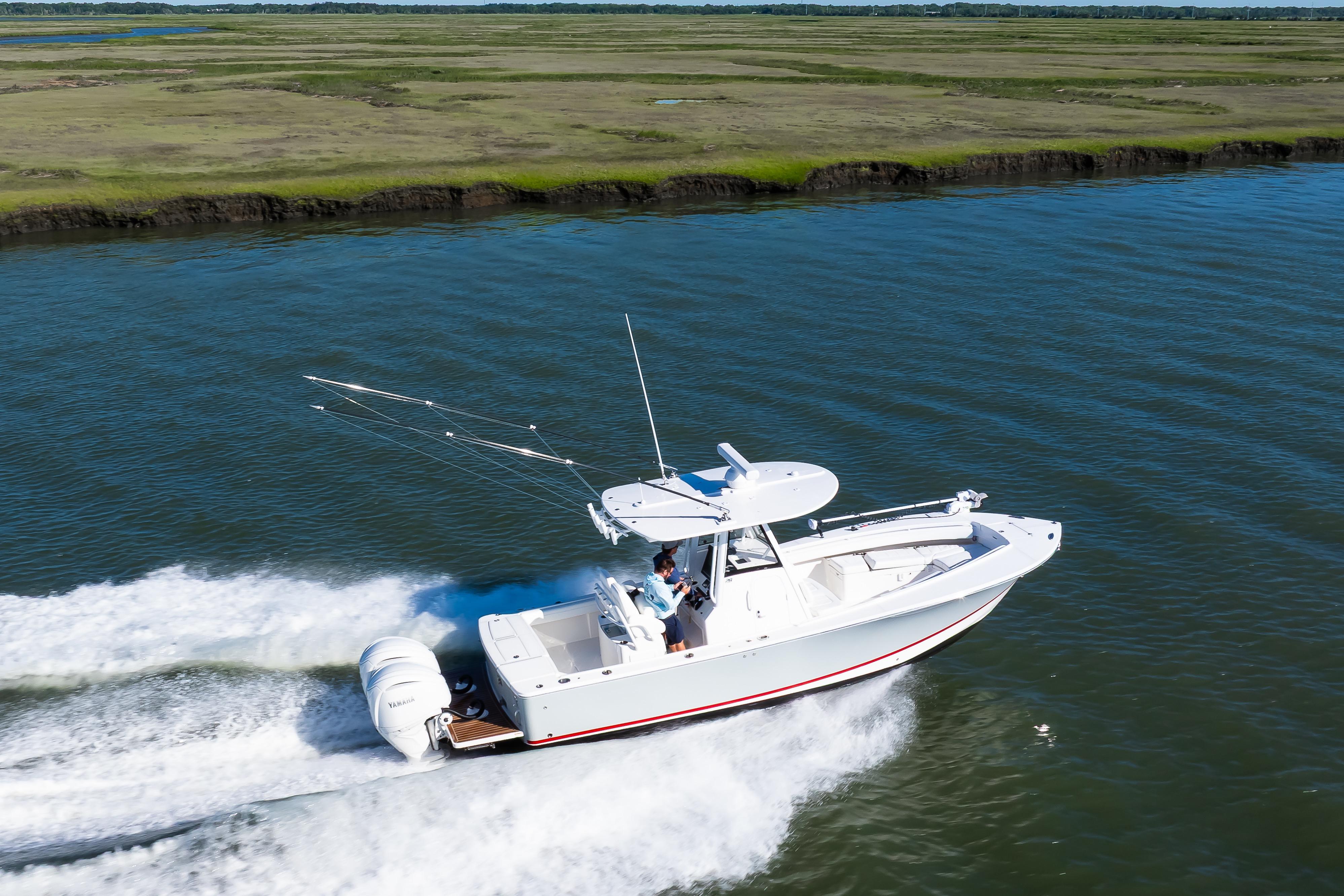 2022 Regulator 28 Forward Seating boat cruising on a scenic waterway.
