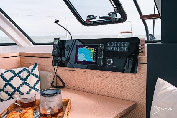 2025 Nautitech 40 Open yacht interior with navigation system and breakfast setup.