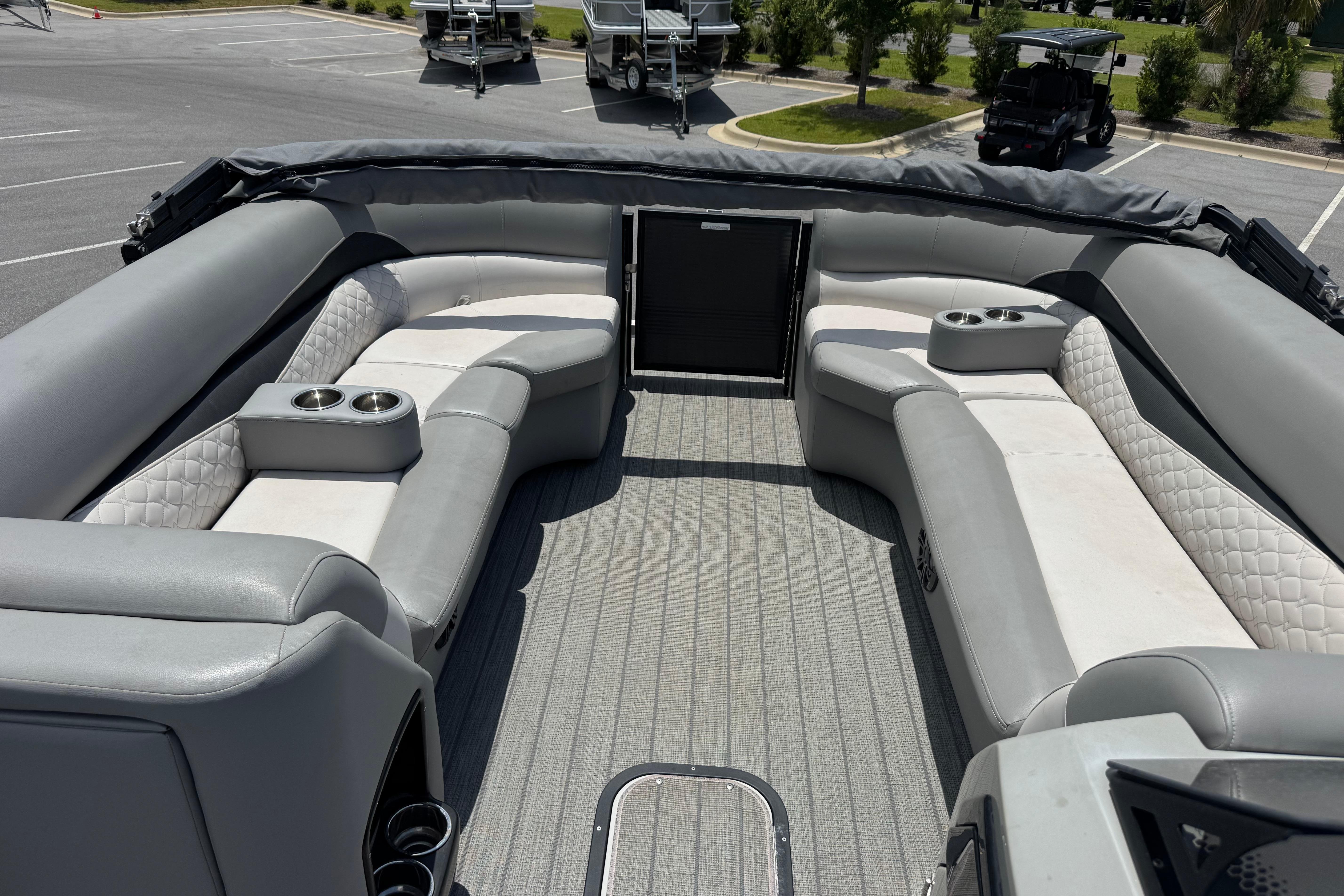 2022 Manitou 25 Encore pontoon boat interior with gray seating and cup holders.