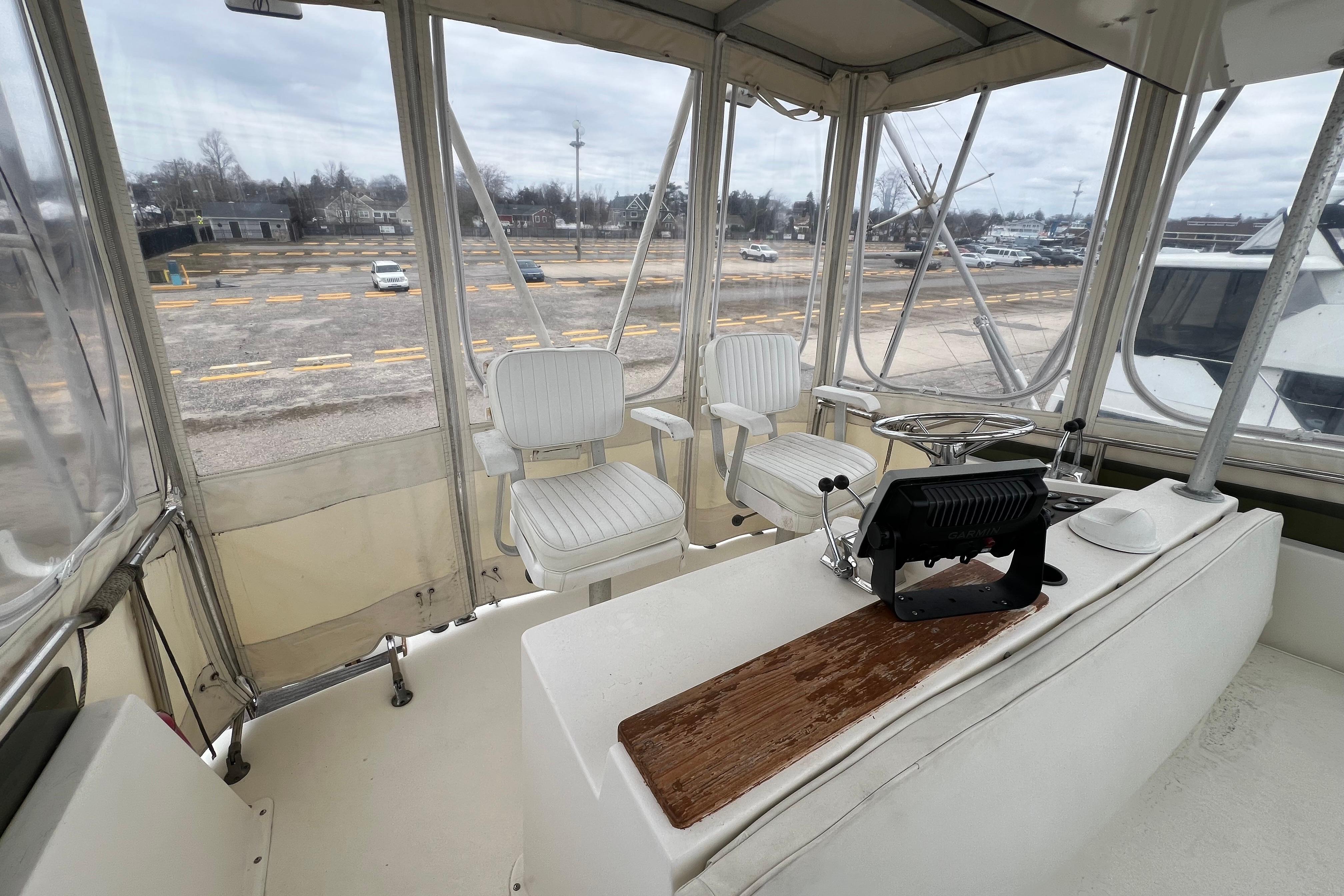 Interior view of 1989 Egg Harbor 35 Sport Fisherman boat cockpit with seating and controls.