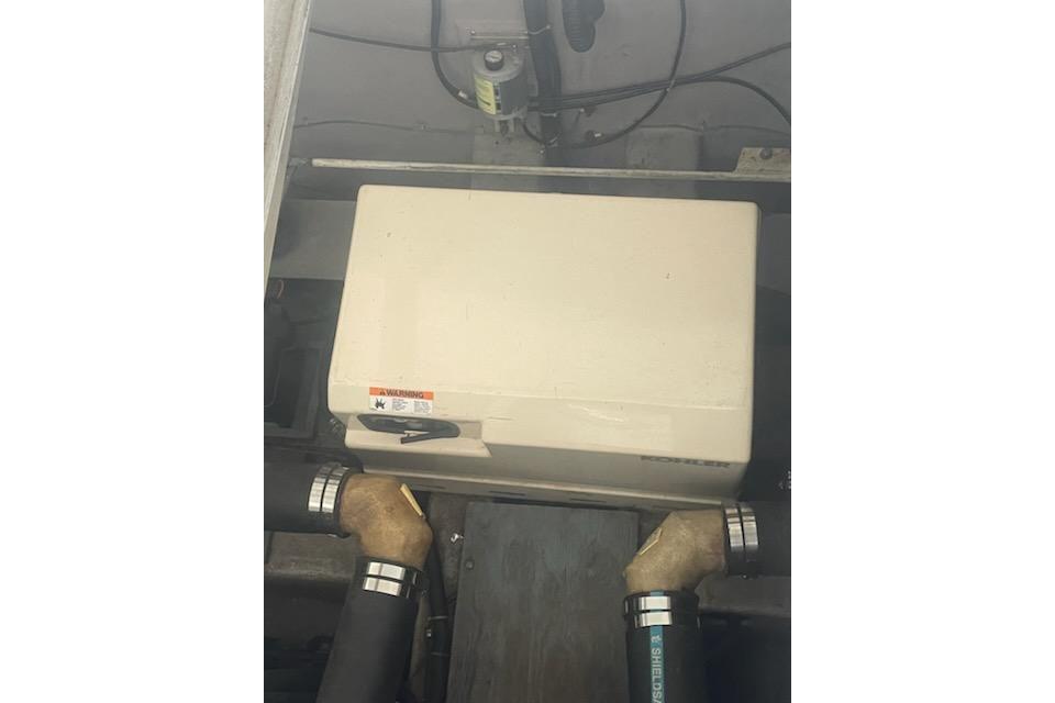 1990 Carver 34-38 engine compartment with generator and hoses.